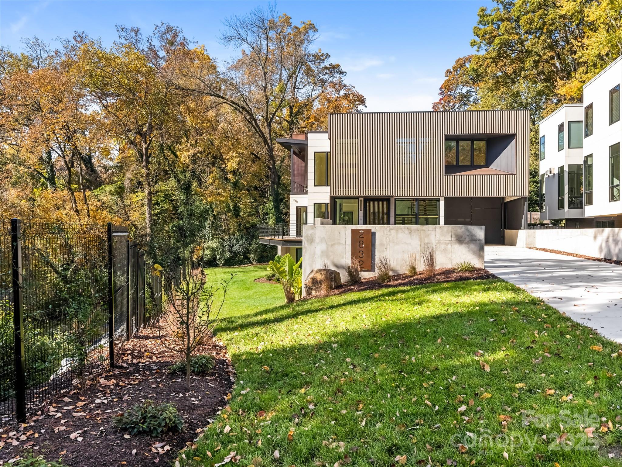 Experience modern living at its finest in this stunning new construction home designed by Peadon Finein and built by Halley Douglas.  Located on a beautiful lot in Myers Park situated on a bluff overlooking Briar Creek with beautiful forest views. The home has 5 bedrooms, 5 1/2 baths in the main house and a secondary living space/entertainment room with full bath over a detached garage.  Enter into a dramatic foyer with floor to ceiling windows and into an open floor plan featuring abundant natural light. Top of the line gourmet kitchen features beautiful custom cabinetry, large island with Thermador appliances. Kitchen opens to a gracious family room overlooking outdoor porch and pool. Second level offers gorgeous primary suite with a private porch and fireplace with treetop views. The primary bathroom has heated floors & spacious custom closets. Three ensuite secondary bedrooms complete upper floor. Two car detached garage with additional gated covered parking. Exceptional home!