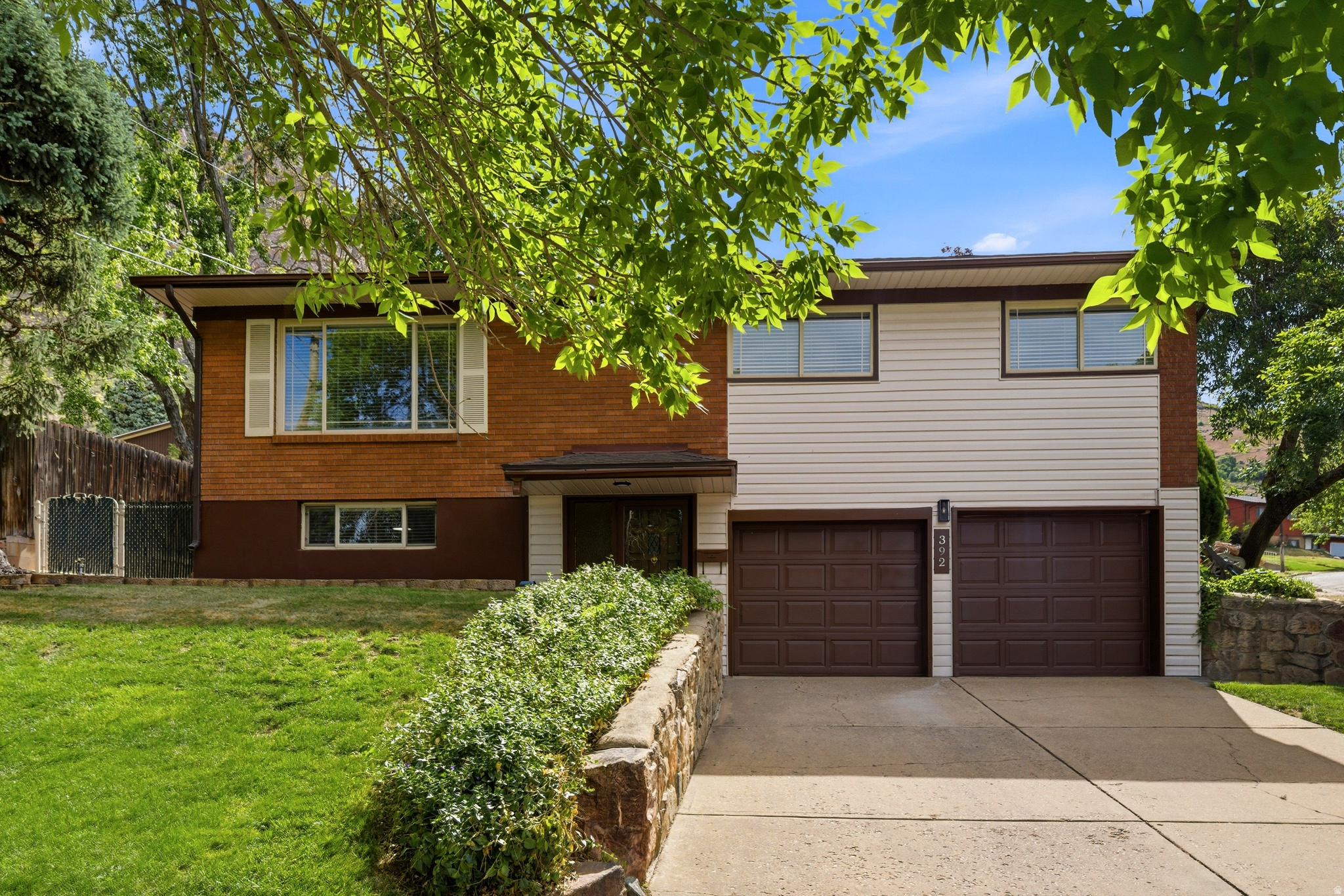 Beautifully remodeled home nestled on Ogden's desirable East Bench. With stunning mountain views, this home offers a bright, open living space. Featuring large windows that fill the home with natural light, recessed can lighting throughout, and gorgeous new LVP flooring. The updated kitchen is both stylish and functional, the perfect space for gathering and everyday living. Outside, enjoy a fully fenced backyard with turf. No watering worries here! Relax under the covered patio, unwind in the hot tub, and enjoy added storage with the backyard shed. Pet lovers will appreciate the dedicated outdoor kennel area for dogs. Situated on a beautiful corner lot with mature trees, this property also features a 2-car garage and combines comfort, convenience, and outdoor enjoyment in one exceptional package. New Water Heater, Roof replaced in last 5 years. This home is ready to enjoy!