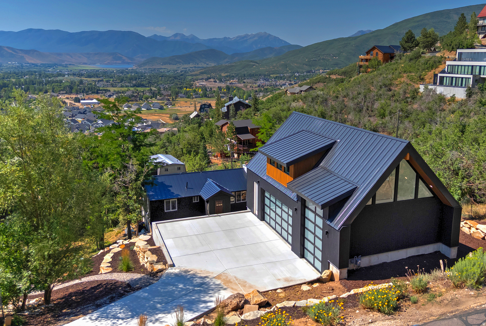 Some homes are renovated. This one was reimagined - down to the studs - by an owner chasing a final dream property, resulting in a move-in-ready, fully modernized mountain home with a genuinely rare opportunity built in.  Two features set it apart in Interlaken: rough plans to connect the home to the garage for a 3,500+ sq ft dream estate, and an oversized 3-car RV garage - a true rarity here. For a buyer with vision, this isn't just a finished home; it's a development platform. The expansion means building your own dream addition without buying raw land or starting permits from scratch, while the RV garage offers both a lifestyle asset and income potential from RV/boat storage - in real demand in Interlaken.  Life had other plans for the current owner (a wedding and an out-of-state relocation), leaving that vision - and this opportunity - for the next buyer to run with. Between 2023 and 2026, the home was rebuilt with all-new electrical, plumbing, a relocated staircase, and structural reinforcement including a steel I-beam to open the kitchen. The primary suite was created by combining two bedrooms and a bath, with a new half bath added upstairs and a wet bar finished downstairs. New LVP flooring, quartz countertops, a tiled fireplace, all-new appliances, fresh insulation, and full re-sheetrock and paint round out the interior. Even the furnace is new.  2025 brought a metal roof and new AC; 2026 delivered a completed garage, 7-zone irrigation landscaping, retaining walls, a stone staircase, and a rebuilt deck.  The result: 2 bed, 2.5 bath, 847 SF main, 801 SF finished basement, plus a 564 SF bonus loft above the garage - ready to finish as a kitchenette-and-bath ADU or roll into the larger expansion. A nearly-new home with the heavy lifting done, and a real path to make it even more.