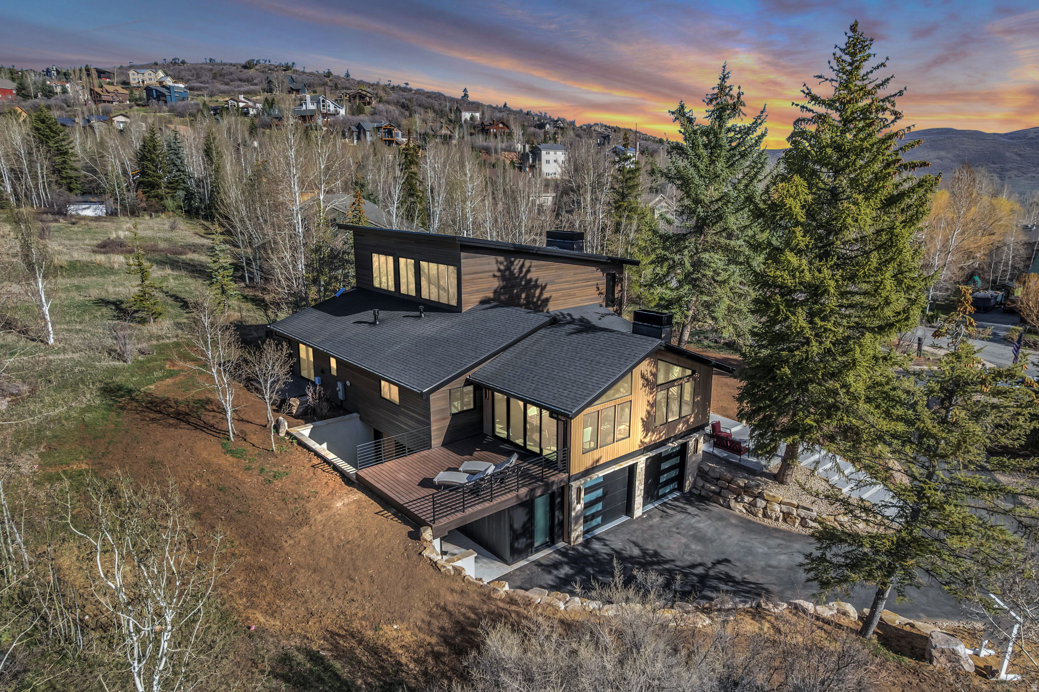 Welcome to this newly reconstructed Pinebrook masterpiece, where mountain elegance meets modern luxury in one of Park City's most desirable neighborhoods. Perfectly positioned on a peaceful .62 acre lot surrounded by mature pines, graceful aspens, and charming apple trees. This exceptional home offers a rare combination of privacy, beauty, and convenience. Just minutes from shopping, parks, trails, tennis, pickleball, and all the best of the Park City lifestyle. Thoughtfully designed for both effortless everyday living and unforgettable entertaining, the bright, open concept floor plan is filled with natural light and elevated by sophisticated finishes throughout. At the heart of the home, the stunning chef's kitchen is a true showpiece, featuring premium Wolf appliances, Sub-Zero refrigeration, two Asko dishwashers, a microwave drawer, wine refrigerator, and a beautifully finished pantry. Perfectly suited for everything from quiet mornings to hosting on a grand scale.  Create the mood by easily casting your playlist throughout on the build in Sonos sound system.  The main level primary suite is a luxurious private retreat, complete with its own deck, cozy fireplace, spa inspired soaking tub, oversized shower, and a sense of serenity that makes coming home feel like an escape. Two additional bedrooms with a full Jack and Jill bath accompany the primary suite on the main level, offering comfort and functionality for family or guests. Upstairs, the home transforms into an entertainer's dream with a spacious wet bar, dedicated theater, and ample room for a pool or game table, while the adjoining flex room showcases magnificent uphill views and offers endless possibilities as a home office, fitness studio, or an unforgettable bunk room. Adding tremendous flexibility and value, the lower level lock-off ADU features its own private entrance, full kitchen, two bedrooms, and a 3/4 bath. This makes it ideal for guests, multigenerational living, or rental income potential. Outside, the large horseshoe driveway provides effortless arrival and abundant guest parking. The oversized garage is purpose-built for mountain living, easily accommodating two heavy-duty trucks with extra length and an adjacent gear room to keep all your equipment dry, organized, and adventure ready. Window coverings are included and may be color selected by the buyer, and sod for the flat front yard will be installed in April, adding the finishing touch to this extraordinary property. Located just 10 minutes from PCMR Canyons Village and only 25 minutes from Salt Lake City International Airport. This is more than a home, it's a rare opportunity to live beautifully, entertain effortlessly, and experience the very best of Park City living.