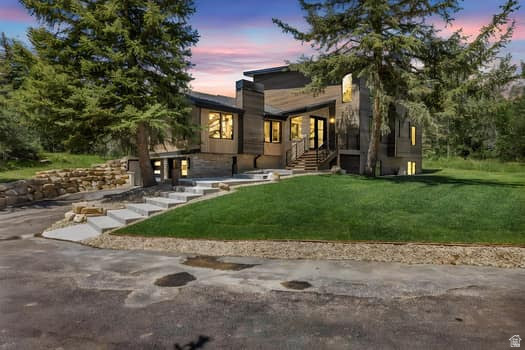 Welcome to this newly reconstructed Pinebrook masterpiece, where mountain elegance meets modern luxury in one of Park City's most desirable neighborhoods. Perfectly positioned on a peaceful .62 acre lot surrounded by mature pines, graceful aspens, and charming apple trees. This exceptional home offers a rare combination of privacy, beauty, and convenience. Just minutes from shopping, parks, trails, tennis, pickleball, and all the best of the Park City lifestyle. Thoughtfully designed for both effortless everyday living and unforgettable entertaining, the bright, open concept floor plan is filled with natural light and elevated by sophisticated finishes throughout. At the heart of the home, the stunning chef's kitchen is a true showpiece, featuring premium Wolf appliances, Sub-Zero refrigeration, two Asko dishwashers, a microwave drawer, wine refrigerator, and a beautifully finished pantry. Perfectly suited for everything from quiet mornings to hosting on a grand scale.  Create the mood by easily casting your playlist throughout on the build in Sonos sound system.  The main level primary suite is a luxurious private retreat, complete with its own deck, cozy fireplace, spa inspired soaking tub, oversized shower, and a sense of serenity that makes coming home feel like an escape. Two additional bedrooms with a full Jack and Jill bath accompany the primary suite on the main level, offering comfort and functionality for family or guests. Upstairs, the home transforms into an entertainer's dream with a spacious wet bar, dedicated theater, and ample room for a pool or game table, while the adjoining flex room showcases magnificent uphill views and offers endless possibilities as a home office, fitness studio, or an unforgettable bunk room. Adding tremendous flexibility and value, the lower level lock-off ADU features its own private entrance, full kitchen, two bedrooms, and a 3/4 bath. This makes it ideal for guests, multigenerational living, or rental income potential. Outside, the large horseshoe driveway provides effortless arrival and abundant guest parking. The oversized garage is purpose-built for mountain living, easily accommodating two heavy-duty trucks with extra length and an adjacent gear room to keep all your equipment dry, organized, and adventure ready. Window coverings are included and may be color selected by the buyer, and sod for the flat front yard will be installed in April, adding the finishing touch to this extraordinary property. Located just 10 minutes from PCMR Canyons Village and only 25 minutes from Salt Lake City International Airport. This is more than a home, it's a rare opportunity to live beautifully, entertain effortlessly, and experience the very best of Park City living.