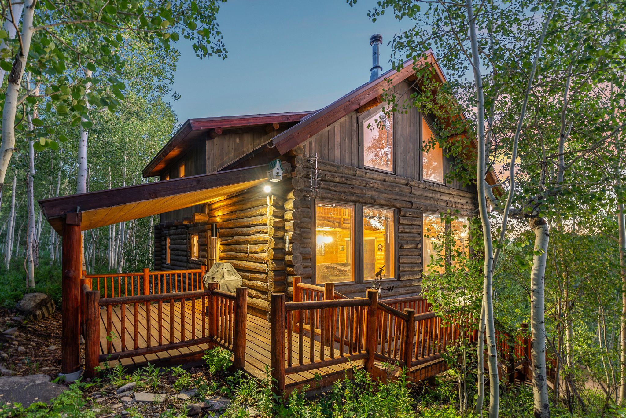 Exceptional mountain retreat and value opportunity in Timber Lakes Estates! This beautifully maintained 1991 log cabin offers 3 bedrooms, 2 full bathrooms, and a desirable main-level primary suite, all set on a private and usable 0.57-acre lot surrounded by towering aspens and mountain serenity. Recently re-stained and thoughtfully updated with new light fixtures and a new Trex deck with decorative hog-wire railing and a gas BBQ line, creating the perfect setting for relaxing or entertaining in the fresh mountain air. Approximately 900 sq ft of unfinished lower-level garage/shop space offers outstanding potential for a one-car garage, workshop, expanded recreation area, or future living space with added equity upside. Located within a private guard-gated mountain community just 7 miles east of Heber City with direct access to thousands of acres of Uinta Fational Forest and endless year-round recreation including ATV riding, hiking, snowmobiling, skiing, golfing, boating, fishing, and more. Just 30 minutes to Park City and approximately one hour to Salt Lake City or Provo. Timber Lakes is a guard-gated year-round mountain community just 7 miles East of Heber City where owners enjoy year-round utilities and maintained roads and all the convenience of living in the mountains, just minutes from town.