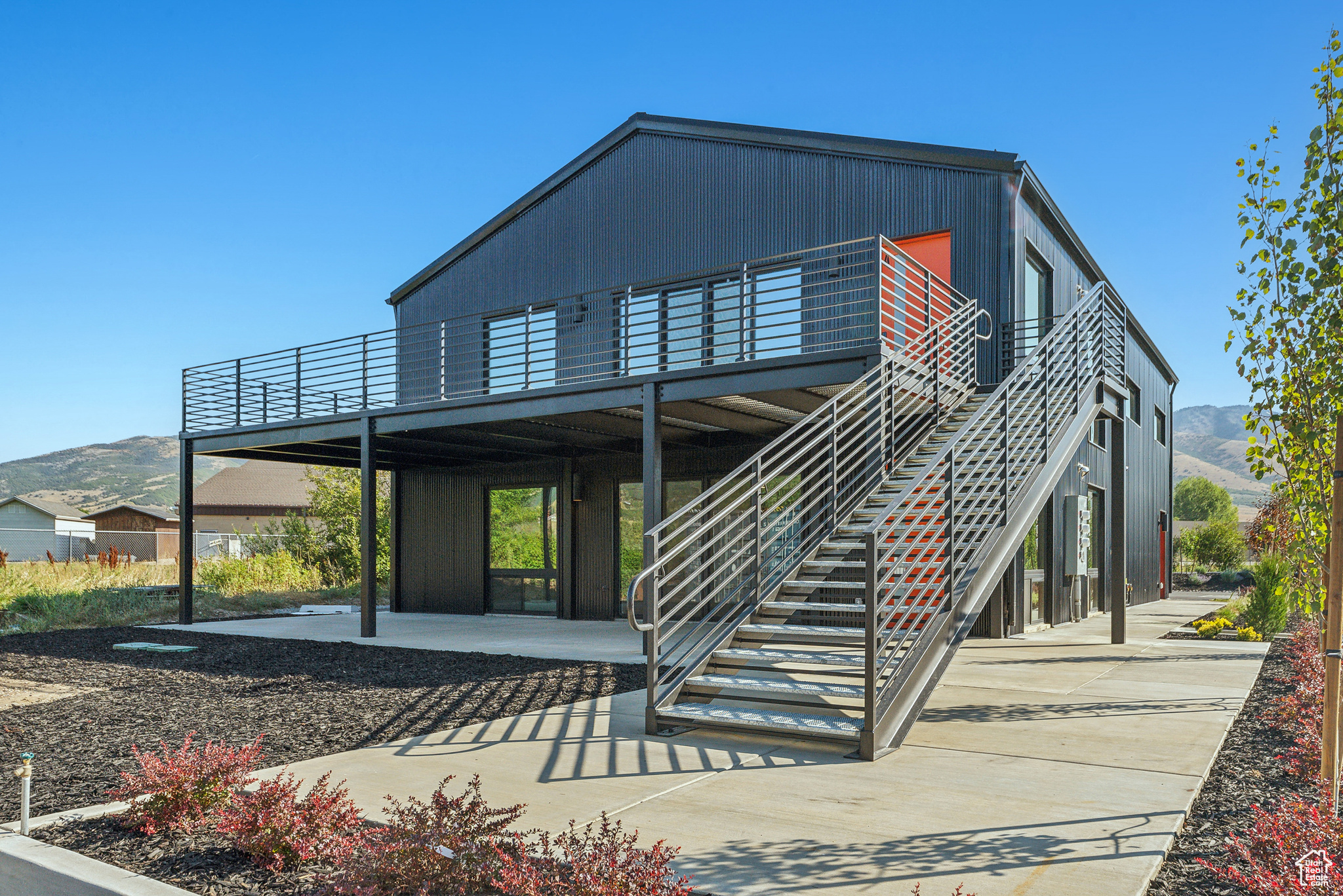 New building located in the heart of Eden's Business District.  Zoned CV2.  Clad in black corrugated steel, this building is filled with abundant natural light, has stunning mountain views, and was designed in a sophisticated Hygge Style.     As you walk across the expansive patio and into this upper level apartment you will be inspired by the bright openness of this space. You will be in awe as you look out towards Nordic Ski Resort, Ben Lemond Mountain, and you'll even be able to see Pineview Reservoir off in the distance.  Cosy up in the living room with it's gas fireplace.  The modern kitchen will be your perfect spot to make breakfast and your morning coffee.  Stacking washer and dryer are an additional convenience with-in the unit.  There is even a loft space that could be a fab reading nook, with supplemental storage closets.  There are two bedrooms, one with an ensuite bathroom.  Large format tiles add to the modern flare of the bathrooms.  All rooms have mini-split HVAC systems. Property is leased through the winter and will be available for lease again June.