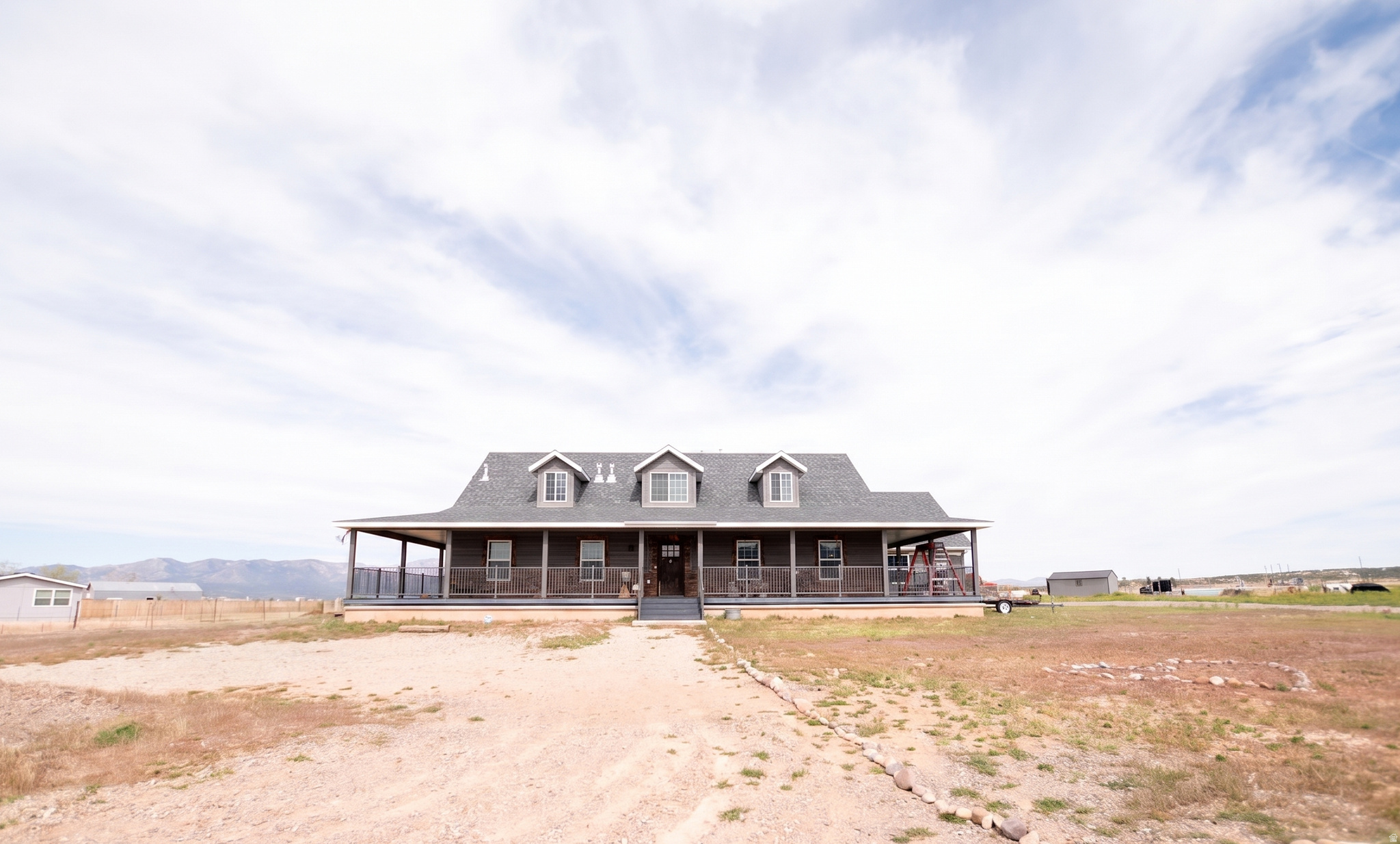 Experience upscale country living at its finest. This beautiful, large 7-bedroom, 5-bath home sits on 4.79 acres of private, picturesque landscape. A wrap-around porch invites you to unwind and soak in unobstructed, panoramic views that stretch across the countryside. Inside, the generous floor plan flows with airy living spaces that are perfect for entertaining, multi-generational living, or hosting guests. With seven bedrooms and five baths, there's ample room for family, live-in staff, or a dedicated home office and workout spaces-each room bathed in natural light and timeless finishes. The property's outdoor canvas is equally impressive. The expansive grounds offer endless possibilities for outdoor recreation, gardening, and hobbies. Animal lovers will appreciate the freedom to keep pets or livestock, making this a superb setting for animal enthusiasts or hobby farming.