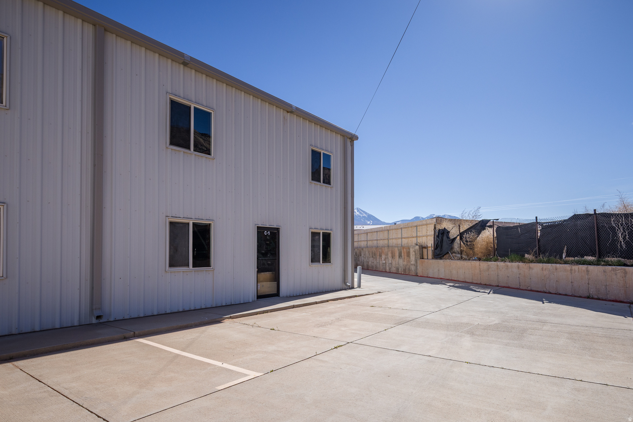 MOAB BUSINESS PARK C1 Exceptional flexible-use industrial space ideally positioned just off Highway 191 with excellent visibility and easy access. This versatile condominiumized warehouse space is well suited for a variety of business uses including a shop, retail, or office.  A blank canvas to customize and build out to meet your specific needs, as well as adding residential living quarters. The complex is home to a dynamic mix of established businesses, creating a strong commercial environment just south of Moab. An outstanding opportunity to secure a highly adaptable space and position your business for growth in Moab's Business Park.