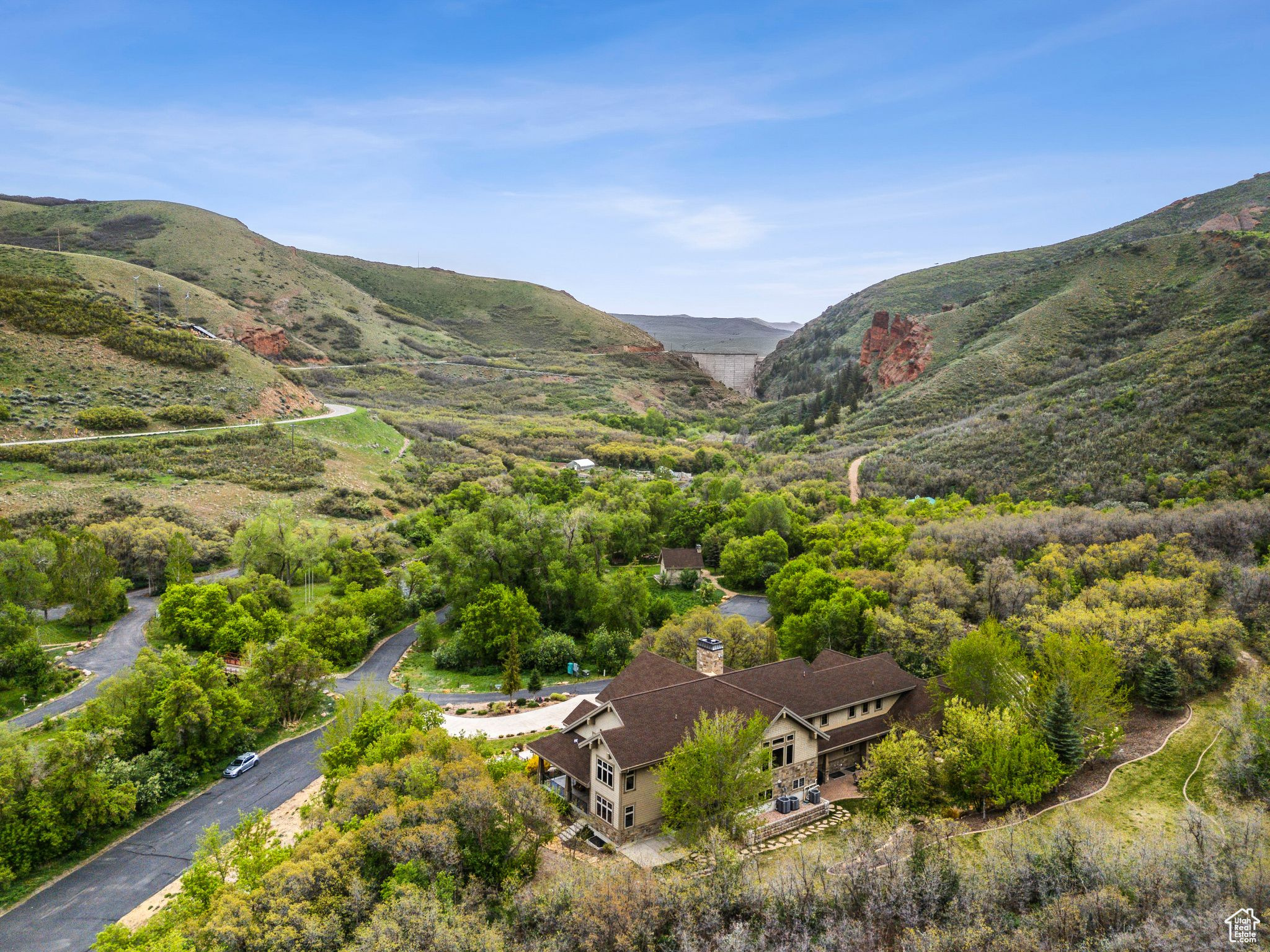 Welcome to Tifie Ranch  a spectacular 167-acre mountain retreat along the scenic East Canyon Creek. Nestled in the heart of Morgan Valley just off HWY 66, this extraordinary legacy property offers unmatched privacy, natural beauty, and versatility.  The estate features a stunning 7-bedroom, 7-bathroom lodge, thoughtfully designed with comfort and luxury in mind. Inside, you'll find rich madrone wood flooring and beautiful cherry wood cabinets throughout, adding warmth, character, and timeless craftsmanship to the home. The lodge also includes two private basement apartments-ideal for guests or extended family-providing both convenience and flexibility. Surrounding the main lodge are three charming guest cabins, two fully equipped entertainment pavilions with kitchens and bathrooms, as well as two remote yurts and multiple glamping sites along the creek.  Perfect for private enjoyment or hosting unforgettable events, the ranch also boasts an on-site amphitheater-an incredible venue for concerts, weddings, or large gatherings set against a backdrop of mountain vistas. Additional amenities include six RV pads with full hookups, a heated four-bay RV garage/workshop with a bathroom and shower, a greenhouse, a designated grow area, and nearly a quarter mile of year-round creek winding through wooded terrain and wide-open spaces.  Tifie Ranch is built for self-sufficiency, powered by a combination of solar, wind, and hydro systems, with a backup grid connection. A 70,000-gallon water tank and multiple septic systems ensure reliable utilities.  Ideally located between Park City and Morgan, this is more than a home-it's a destination. Survey available upon request for serious buyers.  Buyer is responsible to verify all listing information, including square footage and acreage, to their own satisfaction.