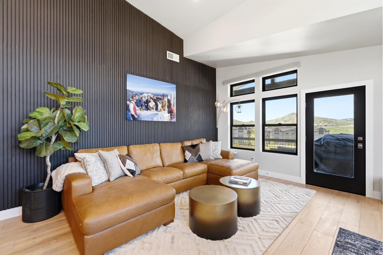 This beautiful, modern, well-appointed condo offers a clean, contemporary feel with views of Jordanelle Reservoir and an ideal layout. Coming fully furnished, all you need is your toothbrush!   The open great room features a striking inlaid wood accent wall that adds warmth while maintaining a modern aesthetic. A contemporary kitchen flows seamlessly into the living and dining areas, making the space equally suited for entertaining or quiet nights in. Large windows welcome the morning sun, and a private balcony brings in natural light and showcases the peaceful lake views.   Enjoy access to a clubhouse, seasonal pool and hot tub. With Jordanelle Reservoir just outside your door and Deer Valley East Village nearby, this condo offers a rare blend of lake, mountain, and ski-centric living.