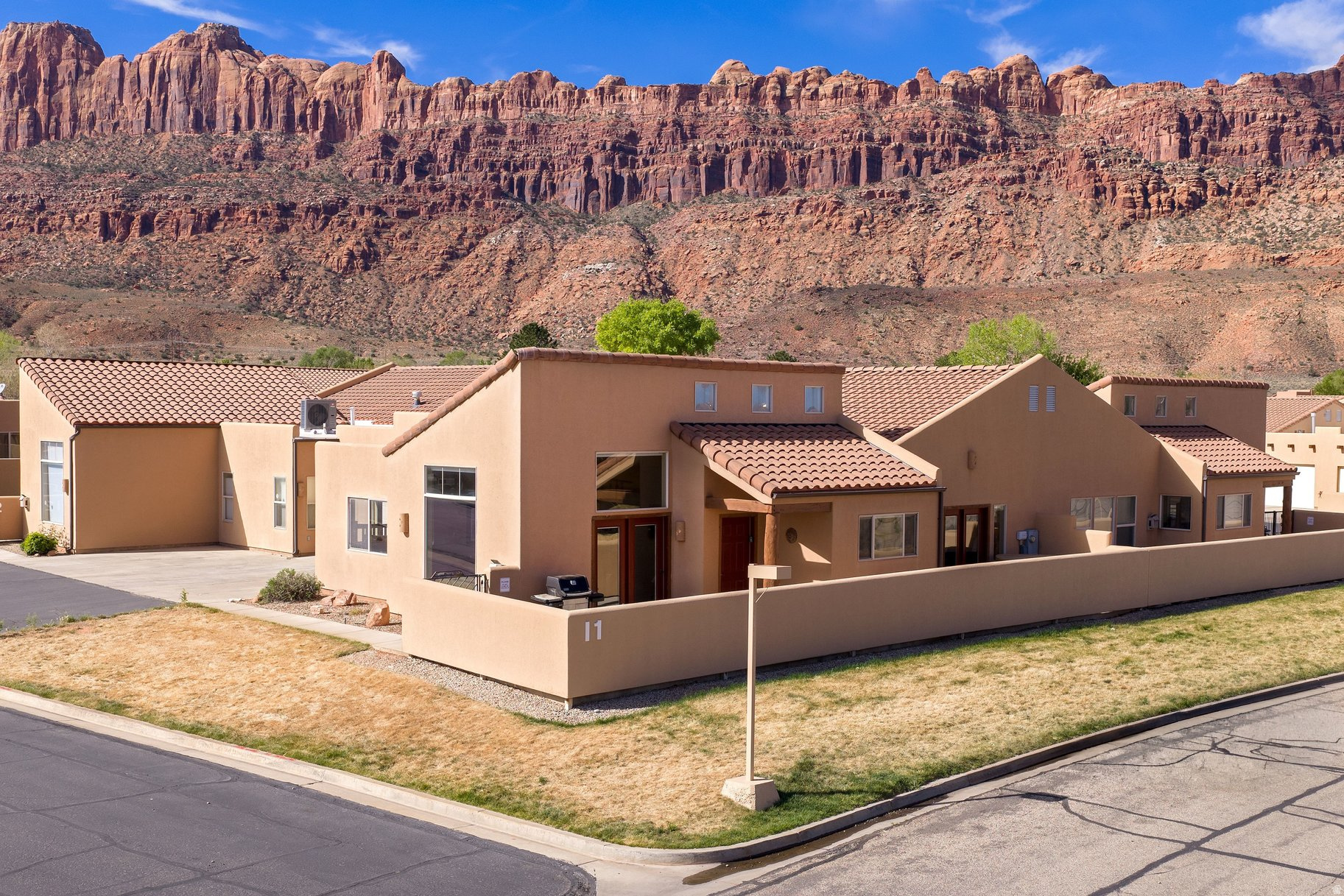 Exceptional Rim Village Unit  Nightly Rental Opportunity! Welcome to your perfect Moab retreat in Rim Village, where comfort, style, and investment potential come together seamlessly. This beautifully appointed 3-bedroom, 2-bath townhome offers an inviting layout accented by elegant slate flooring and warm, cozy touches throughout. Two gas fireplaces create the perfect ambiance, including one in the spacious primary bedroom for a private, relaxing escape. Step outside from the French doors in the primary bedroom to your own hot tub and soak in the stunning desert surroundings after a day of adventure. The home also features a convenient 2-car garage and is ideally located just a short distance from the community pool. Offered fully turnkey, this property is ready to go as a successful overnight rental with a strong rental history, making it an exceptional opportunity for both personal enjoyment and income generation in the heart of Moab. Pool and spa in the common area have been completely upgraded. The spa was enlarged in 2025.