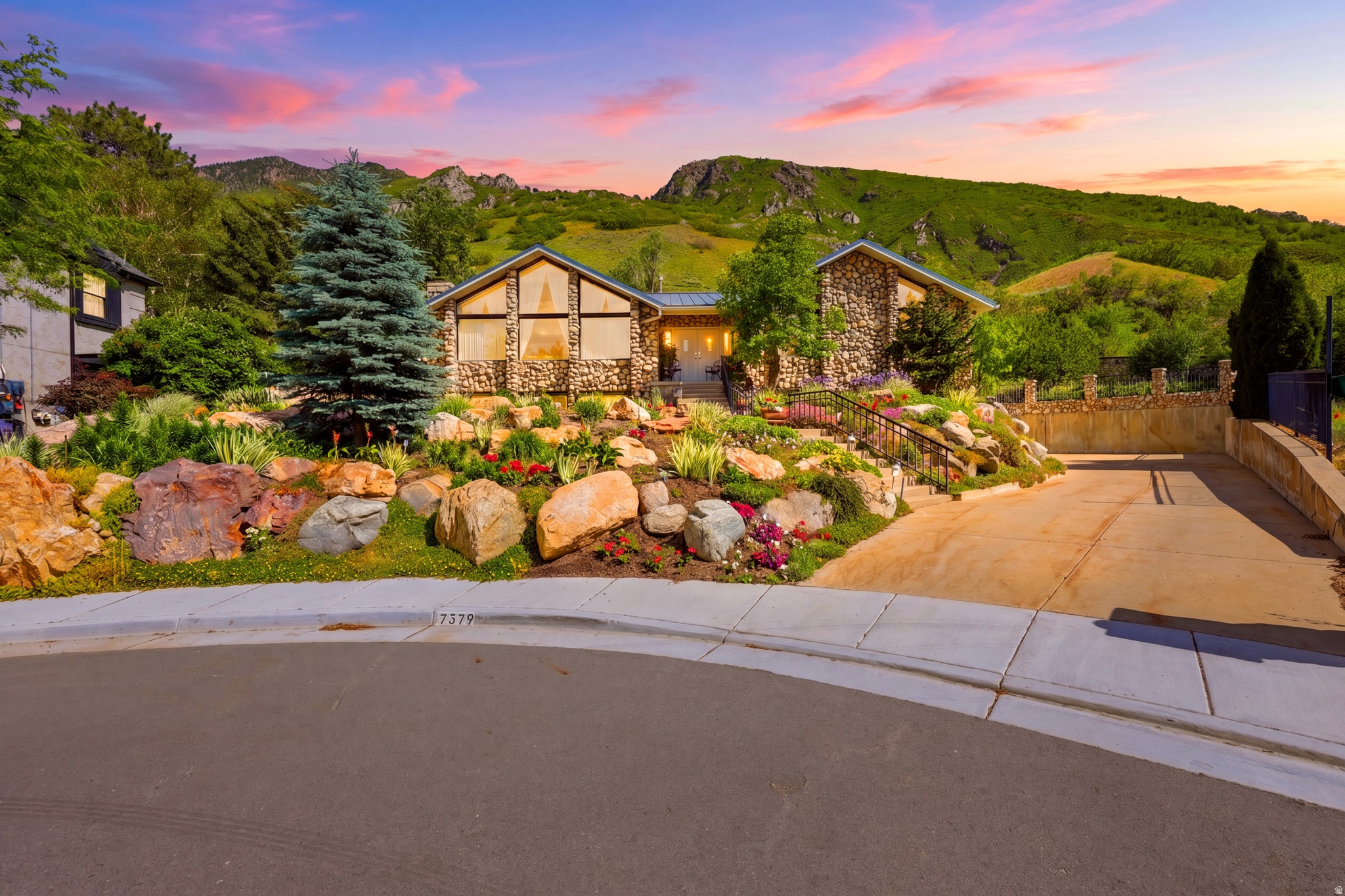 Nestled at the end of a quiet cul-de-sac and backing directly to National Forest land, this extraordinary mountain retreat offers a rare blend of privacy, functionality, and breathtaking natural beauty. From the moment you enter, your eyes are drawn through the home's stunning atrium to the surrounding mountains, creating an immediate connection to the landscape beyond.  Thoughtfully positioned on a beautifully landscaped lot, this property stands apart with one of the few flat driveways in the neighborhood-a significant investment by the owners that provides exceptional convenience, abundant parking, and year-round accessibility. With room for up to 15 vehicles, RV parking, and an impressive 5-car garage/shop configuration, there's space for everything from daily drivers to recreational toys and workshop projects.  Inside, you'll find expansive living spaces featuring vaulted ceilings, a beautiful sunroom, abundant built-in storage, granite countertops, multiple fireplaces, and a spacious primary suite complete with a walk-in closet, separate tub and shower, and spa-like comfort. Recent updates include new flooring and new toilets in the upstairs bathrooms.  Step outside to your own private retreat. The fully fenced and gated heated pool area is designed for both relaxation and peace of mind, while multiple decks and outdoor living spaces provide the perfect setting for entertaining or simply enjoying the mountain views. Wake each morning to mountain views, spend your afternoons beside the pool, and end your evenings with the peace and privacy that only a home bordering a National Forest can provide.  Additional features include a durable metal roof with snow-shedding design, leaf guards, three furnaces, two water heaters, newer water softener, hot and cold water in the garage, EV charging capability, workshop space, and abundant storage throughout.