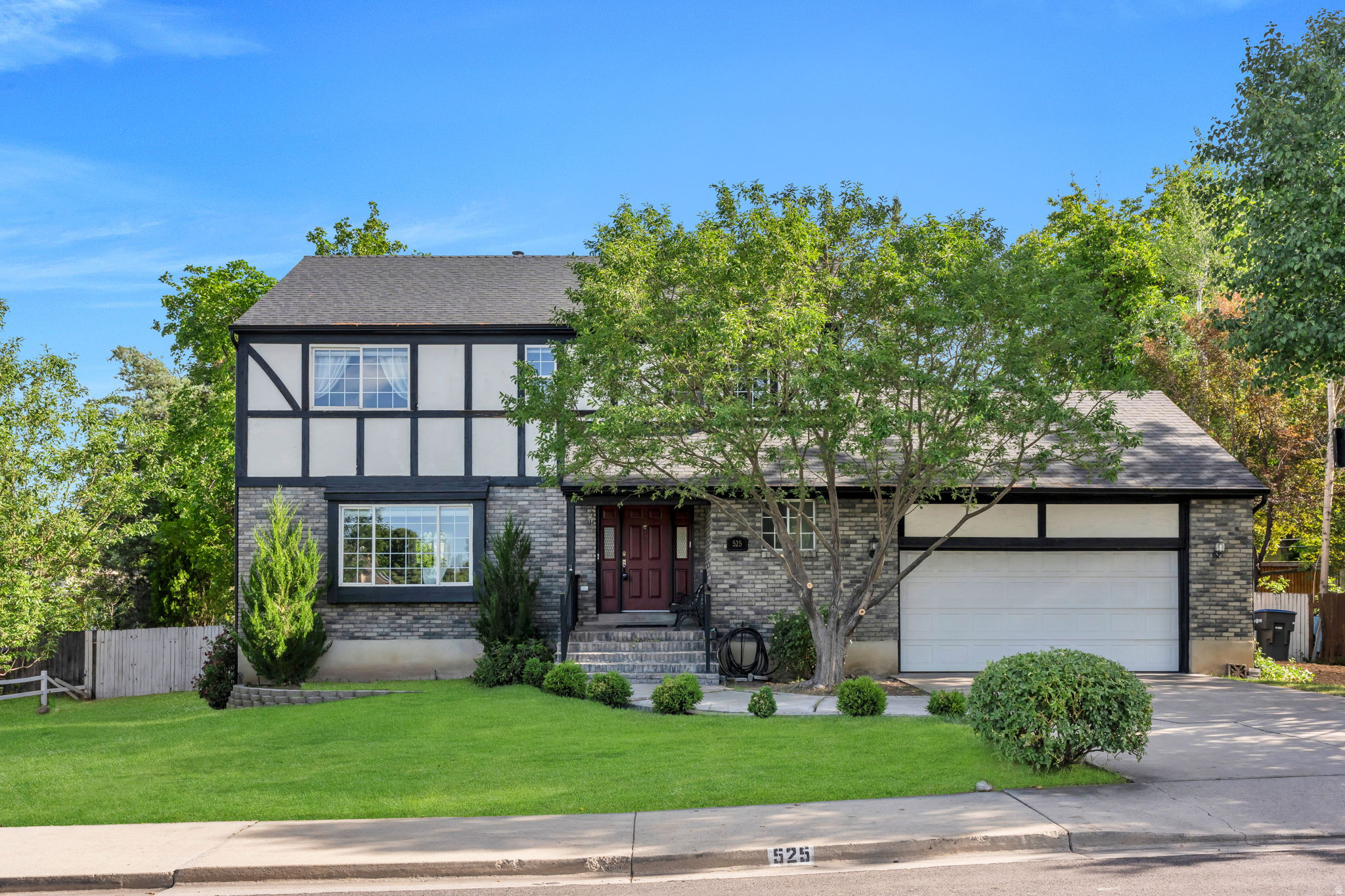 Located in East Provo's highly sought-after Rock Canyon neighborhood, this beautifully updated Tudor-style home offers an unbeatable location within walking distance to all the schools- BYU, Timpview High, Centennial Middle School, Rock Canyon & Edgemont Elementary. The spacious upper level features a private primary suite with 22" deep soaker tub and rain shower along with two additional bedrooms and brand-new carpet. On the main floor, rich hardwood flooring flows through generous gathering spaces, including a large spacious living room, two dining areas, and a warm, inviting family room centered around a charming fireplace. The kitchen is full of character with custom cabinetry, granite countertops, and thoughtful details throughout. The basement offers exceptional flexibility, with the option to seamlessly incorporate it into the main home for additional living space and bedrooms or utilize it as a separate apartment with its own walkout entrance, spacious family room laundry hookups and full kitchen. Newer roof and rain gutters. Outside, the large flat backyard is fully fenced and surrounded by mature trees, creating a private setting perfect for relaxing, entertaining, or enjoying the outdoors.