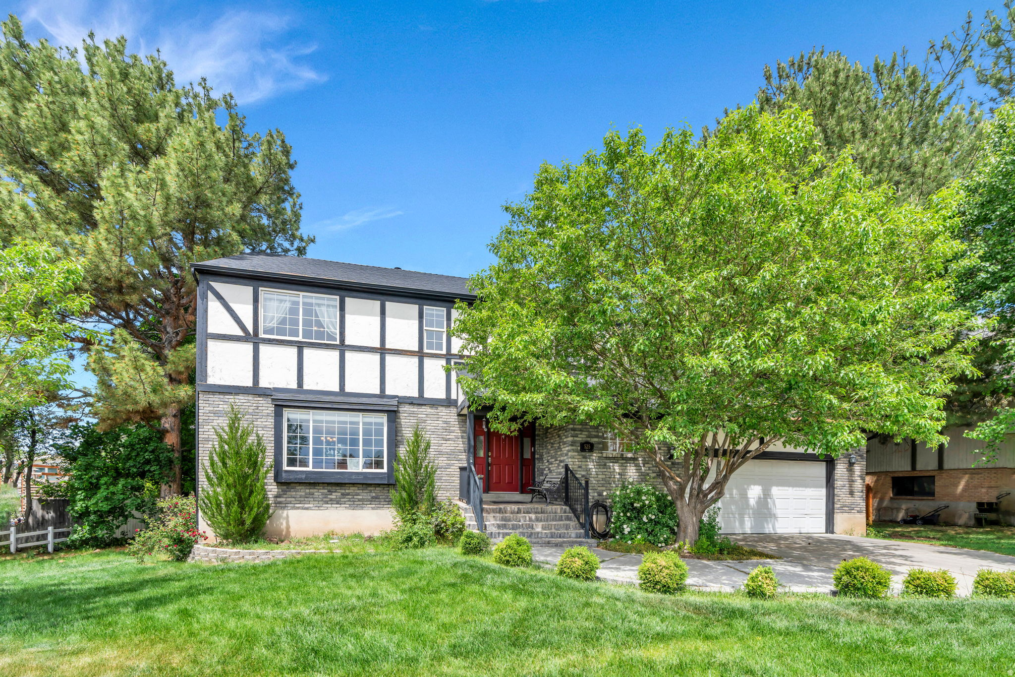Located in East Provo's highly sought-after Rock Canyon neighborhood, this beautifully updated Tudor-style home offers an unbeatable location within walking distance to all the schools- BYU, Timpview High, Centennial Middle School, Rock Canyon & Edgemont Elementary. The spacious upper level features a private primary suite with 22" deep soaker tub and rain shower along with two additional bedrooms and brand-new carpet. On the main floor, rich hardwood flooring flows through generous gathering spaces, including a large spacious living room, two dining areas, and a warm, inviting family room centered around a charming fireplace. The kitchen is full of character with custom cabinetry, granite countertops, and thoughtful details throughout. The basement offers exceptional flexibility, with the option to seamlessly incorporate it into the main home for additional living space and bedrooms or utilize it as a separate apartment with its own walkout entrance, spacious family room laundry hookups and full kitchen. Newer roof and rain gutters. Outside, the large flat backyard is fully fenced and surrounded by mature trees, creating a private setting perfect for relaxing, entertaining, or enjoying the outdoors.