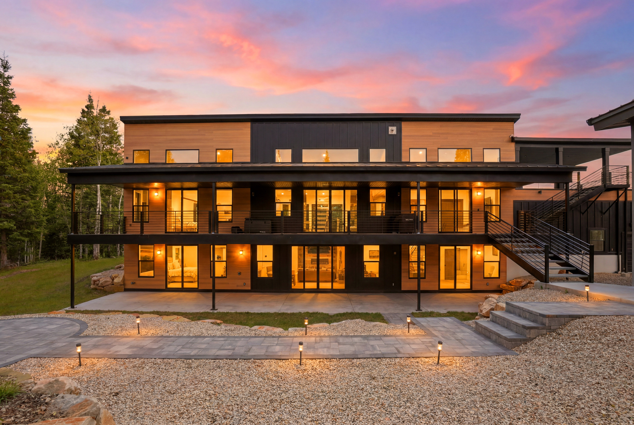 Luxury meets self-sufficiency on 10.38 private acres of pines and aspens in a gated mountain community in Park City. This exceptional home is connected to the electrical grid while also featuring a Tesla Solar Roof with battery backup to keep you powered during power outages, blending cutting-edge energy technology with refined mountain living. An exterior yard fire sprinkler system was installed as an added layer of protection for mountain living. If you're looking for a newer home where thoughtful attention was given to the details, this is it. Completed in 2023, this custom-built retreat offers 7 bedrooms plus a studio guest house, breathtaking mountain views, and seamless indoor-outdoor living with walk-out access at the rear of the home, where four bedrooms open directly onto decks or patios. Designed for both comfort and entertaining, the property features oversized view decks, garage parking for up to eight vehicles, and beautifully landscaped grounds supported by a sprinkler system. Upgraded features you might not notice include 5/8'' drywall throughout, Rockwool insulation in ALL interior walls, blown-in insulation between floors, insulated garages, high-efficiency heat pumps, electrical pre-wired for a hot tub on the back patio, two 1,000-gallon propane tanks in addition to the heat pumps that provide most of the home's heating. The community voted to pave the two main roads, Kimball and Basin, over the next two years, which is a major improvement for the neighborhood. The current owners have already paid their contribution for both years, so no paving assessment will be passed on to the buyer. It is conveniently located just 15 minutes from Kimball Junction, 25 minutes from Park City Main Street and Deer Valley, and 35-45 minutes from Salt Lake City International Airport. It has exceptional privacy without sacrificing convenience. (Total square footage includes both the main home (4,972 sq ft) and the detached studio guest house (823 sq ft), for a total of 5,795 sq ft. Basement 2 in the floor plan/MLS represents the guest house and is not a second basement.)