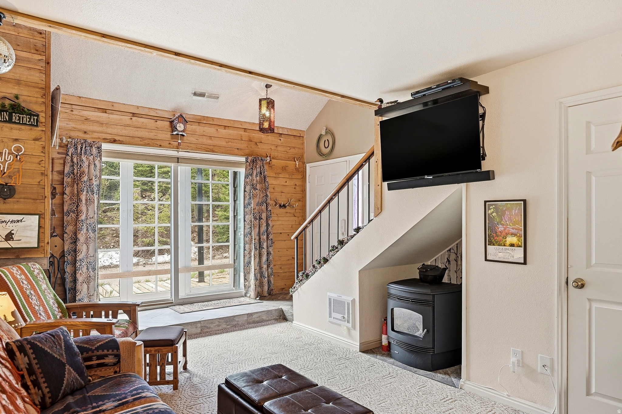 Vibrant and full of personality, this move-in ready, double loft condo offers a welcoming mountain getaway. Vaulted ceilings create an open, airy feel, while the covered deck with movable French doors provides a comfortable spot to take in mountain views year-round. A pellet stove delivers inexpensive, pervasive heat throughout the home, and a wood-burning fireplace adds warmth and mountain charm. With 1.5 baths and versatile loft areas, this cozy retreat is ideal for hosting family and friends. Enjoy cool summer temperatures, easy access to winter recreation, and the added benefit of potential nightly rental income.
