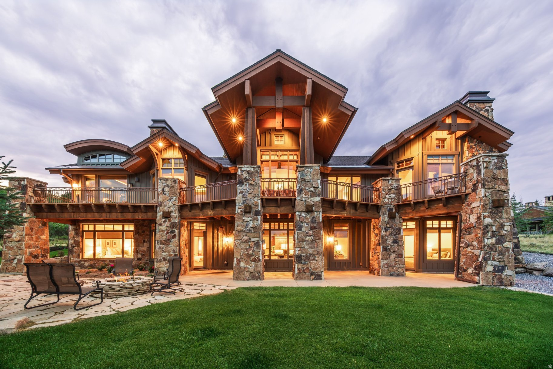 Nestled on a private 1.8-acre homesite along Purple Sage in Glenwild's coveted Phase I, one of the community's most desirable settings, this exceptional Michael Upwall-designed residence offers a rare opportunity to experience the very best of Park City mountain living. Commanding panoramic views of Deer Valley, Park City Mountain, and the surrounding mountain peaks create a breathtaking backdrop that changes beautifully with every season. Thoughtfully reimagined with uncompromising attention to detail, the home strikes the perfect balance between sophisticated elegance and relaxed mountain comfort. Sun-filled interiors, soaring architectural spaces, and seamless indoor-outdoor living invite effortless entertaining, intimate family gatherings, and quiet moments alike. Every room features editorial-quality finishes that have been curated by a professional interior designer, creating a home that feels as comfortable as it is beautiful. The reimagined main-level primary suite serves as an exquisite private retreat, while expansive gathering spaces and beautifully appointed guest accommodations welcome family and friends with ease. Outside, an entertainer's deck spans the length of the home, complemented by a generous lower-level patio, stone fire pit, and cleverly redesigned landscaping that embraces the property's extraordinary setting and spectacular ski mountain views. Glenwild is Park City's only private gated golf neighborhood within the highly regarded Park City School District. Residents enjoy 24-hour gated security, an extensive network of hiking, biking, and walking trails, two parks, and the vibrant Lifestyle Center, the heart of the community's social scene. At its center is the exclusive Glenwild Golf Club & Spa, home to Utah's #1-ranked golf course by Golf Digest, masterfully designed by Tom Fazio. This intimate enclave has just 194 homesites, with the majority of owners living full-time. Club membership is optional and available as a separate purchase. Beautifully updated, impeccably maintained, and positioned in one of Glenwild's premier locations, this extraordinary residence embodies the effortless luxury, enduring quality, and unparalleled lifestyle that define Park City's most sought-after private community.