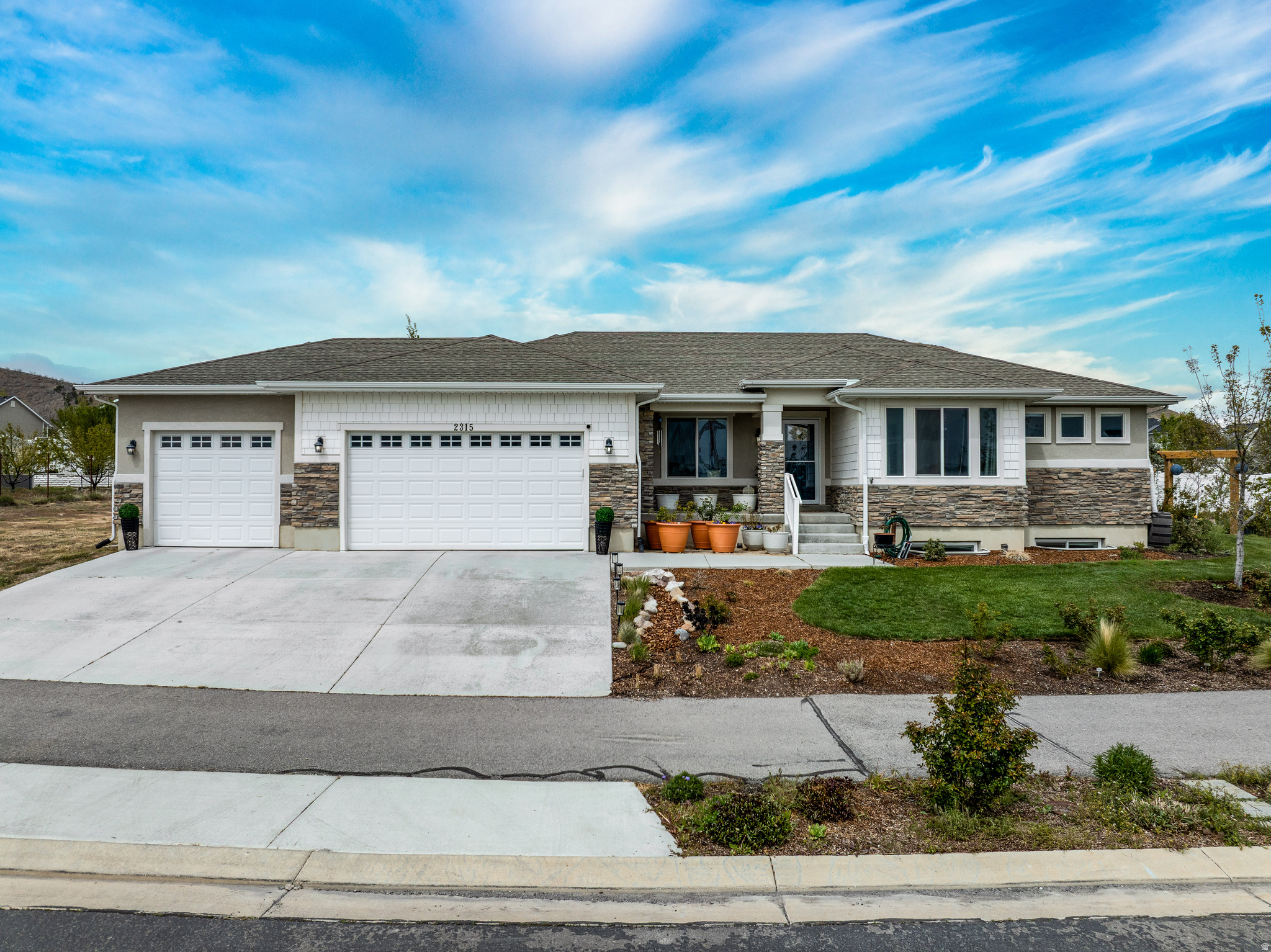 There are homes you tour-and then there are homes you feel. This is the latter.  From the moment you step inside, the open floor plan, vaulted ceilings, and natural light create a sense of ease and connection. The layout invites gathering, conversation, and quiet moments alike-an effortless flow that simply feels right.  But what truly sets this home apart is what awaits beyond the doors.  Step into a garden that has been intentionally created, not just landscaped-a space designed to be experienced. Meandering paths, raised beds, and a welcoming pergola draw you in, while layers of color and texture unfold with every step. At the heart of it all are the remarkable English Roses developed by David Austin, cultivated in the UK and celebrated worldwide for their rich fragrance and classic beauty. Here, they don't just grow-they thrive, filling the air and the space with something rare and memorable. This backyard invites you to slow down and enjoy the moment, surrounded by blooms. Evenings unfold under open skies, while the expansive lawn offers room for kids to run, play games, jump on a trampoline, and enjoy the kind of outdoor space that's getting harder to find.  Set on a spacious -acre lot in Eagle Mountain with sweeping views and room to breathe, this property offers a sense of openness and calm that stands apart. The details are all here-but what can't be captured is how it feels the moment you arrive.  Come experience it for yourself.