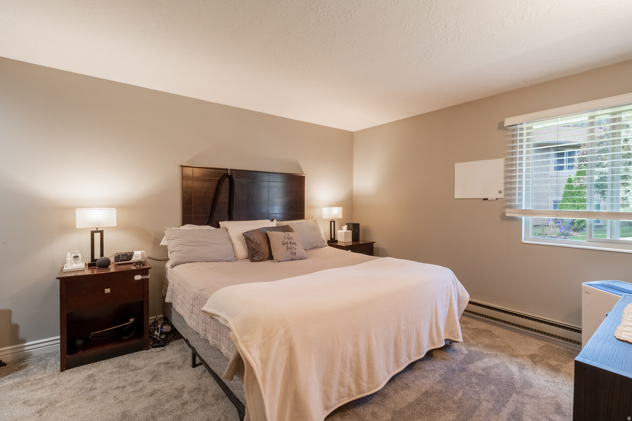 Imagine being five minutes from work and ten minutes from a trailhead.  This South Ogden home offers the kind of lifestyle people move here for. Mountain views, a community pool, a park directly across the street, and Connext Fiber Internet make everyday living easy.  Inside you'll find new carpet and a comfortable layout. Outside, you'll enjoy a dedicated covered parking stall, nearby recreation, and a location that's hard to beat.  Healthcare professionals will appreciate being just minutes from McKay-Dee Hospital, while students, faculty, and staff will love the proximity to Weber State University.  Great views. Great community. Great location. The rest takes care of itself.