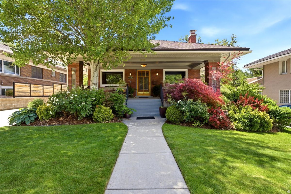 All of the distinctive features of a Craftsman bungalow are perfectly displayed in this lovely Yalecrest residence. The beautifully landscaped front yard leads to the welcoming covered front porch. Step into the open living room, which is framed by gumwood trim and glass-front built-in cabinets. In the adjoining dining room, an impressive stained-glass pendant and original French doors speak to the home's historic roots. The main floor was thoughtfully expanded to include a spacious kitchen, a cozy double-sided gas fireplace, and a peaceful sunroom. The primary suite with an ensuite and a wall of built-in storage, an additional bedroom, and a half bath complete this level. The lower level consists of a family room, two more bedrooms with a Jack and Jill bathroom, laundry, and plenty of storage space.   The remarkable backyard is a serene oasis with the sounds of Red Butte Creek, which flows through the expansive .40 acre property, right at your doorstep. Whether you're enjoying a quiet morning on the stone patio or firing up the grill on the Trex deck, this enchanting space-complete with a hot tub-is built for year-round entertaining. An impressive solar array (with lifetime warranty) is also included. Close to some of the city's top-rated public and private schools. For naturalists who also want to be near the urban center, this property offers a serene creekside setting in the highly coveted Yalecrest neighborhood.