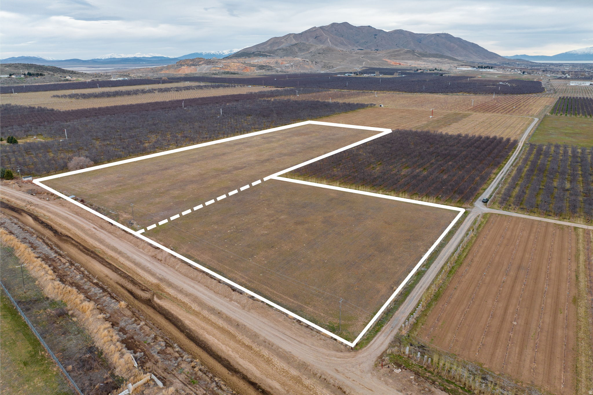 Two parcels of Agricultural zoned property located in unincorporated Utah County, on the Santaquin border. The land was used as an Alfalfa field, but it is surrounded by orchards and other agricultural usages. All water rights included. Close proximity to I-15 and the heart of Santaquin. This transaction includes a total of two parcels to be sold together. They include TAX ID# 29:039:0017 and 29:028:0031. All information is provided as a courtesy and boundaries in photos are approximate. Buyer to verify all information.