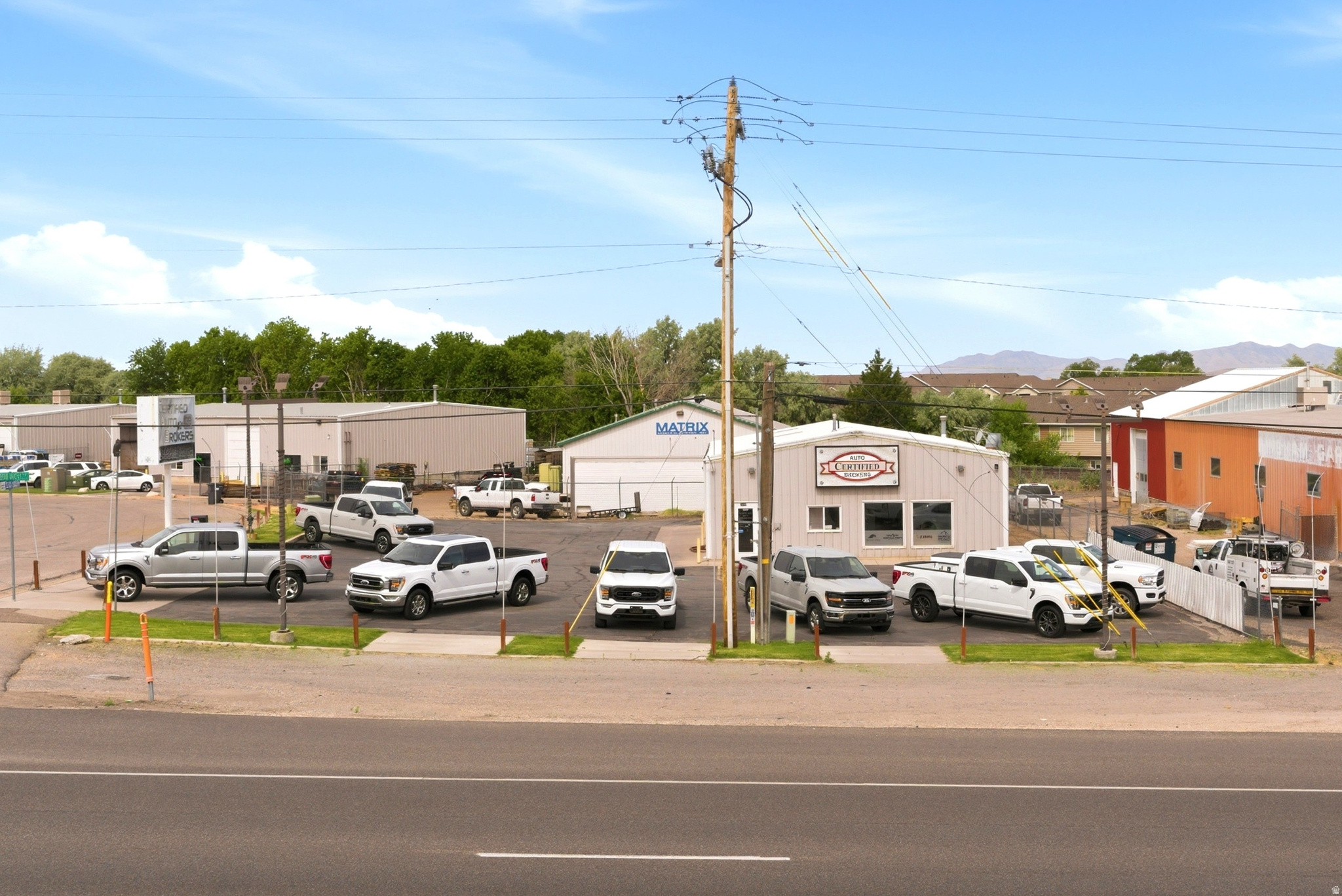 Prime commercial opportunity with exceptional frontage on 1900 W! Currently operating as a successful car lot, this highly visible property is available as the owners retire after 38 years of ownership and operation. The  0.32-acre site has been meticulously maintained and features an 1,862 sq. ft. office/shop building with two 10' x 10' overhead doors, providing excellent flexibility for automotive sales, retail, or contractor uses. The property includes a lighted parking lot and illuminated signage, maximizing exposure to steady daily traffic (2024 AADT = 17,000). Conveniently located near Ogden Industrial Park, West Haven Industrial Park, and Ogden-Hinckley Regional Airport. Quick and easy access to freeway & major roads. Zoned Roy City Manufacturing. A rare chance to acquire a well-established commercial property in a high-visibility location with endless potential.