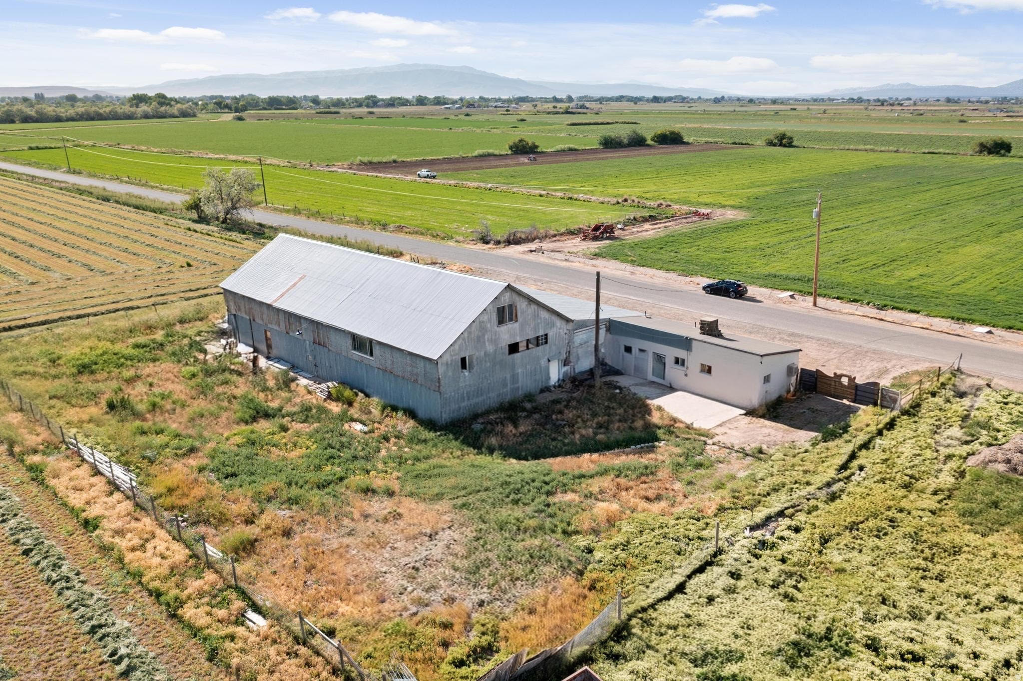 Rare ~6300 sf agricultural building on approximately 0.619 acre in the Spanish Fork area. Existing building includes substantial covered space, a large open barn/storage area, enclosed rooms, and 220 V electrical service. Potential uses may include agricultural operations, farm equipment or product storage, nursery support, or long-term investment. Convenient location with flexible existing space. Property is being sold as-is. Buyer to verify all information and intended use.