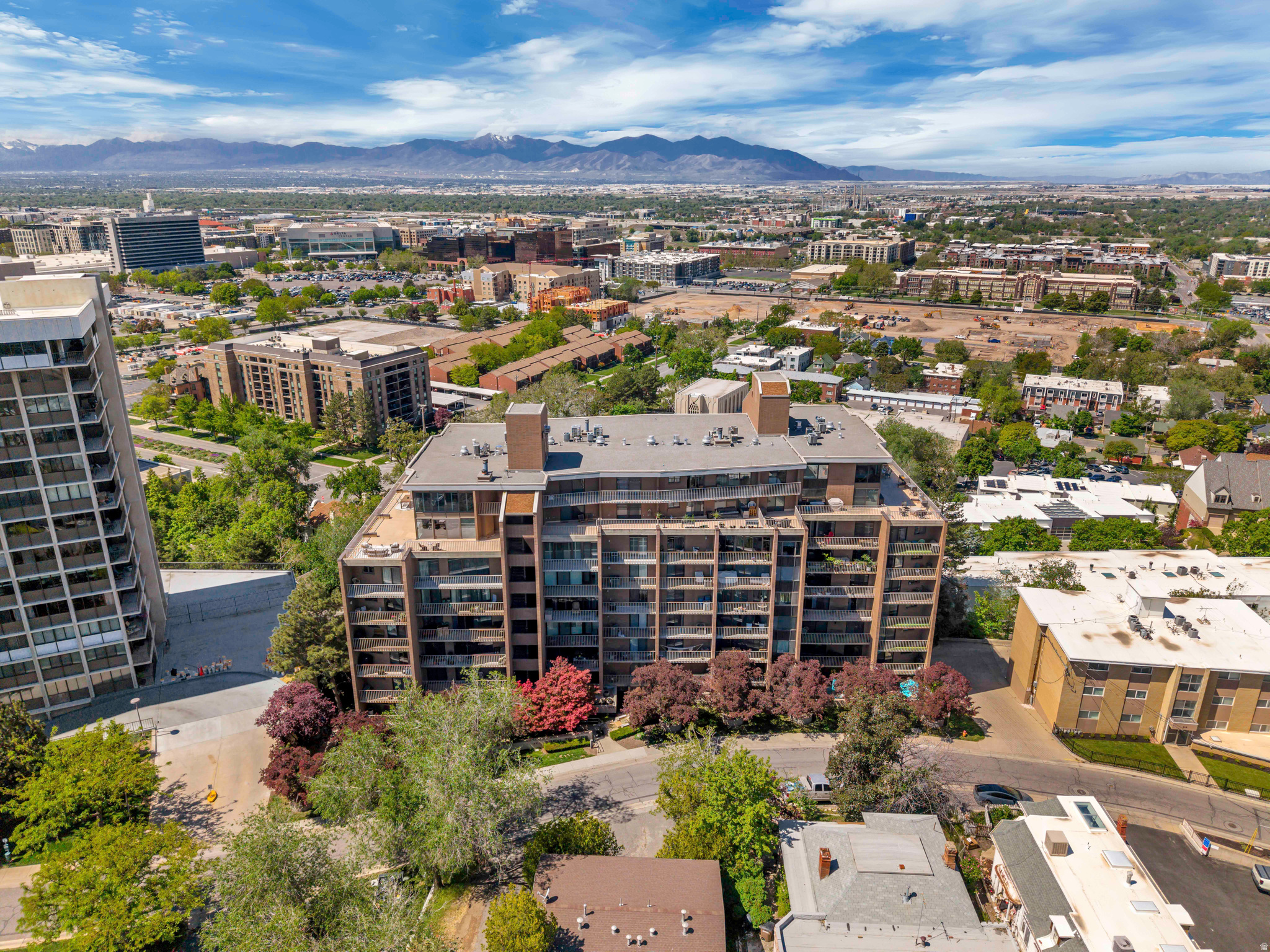 Discover elevated downtown living in this beautifully maintained 2-bedroom, 2-bath condo located in the heart of Salt Lake City with unbeatable walkability to shopping, dining, entertainment, and city attractions, plus convenient access close to the University of Utah. This spacious condo offers a large open gathering space perfect for entertaining, while three private decks showcase incredible panoramic views of the Salt Lake Valley and surrounding mountains. Enjoy the convenience and peace of mind of a secured building requiring key fob access, along with 2 assigned covered parking spaces and 2 private storage closets located in the parking garage. Residents have access to an impressive list of amenities including a pool, hot tub, saunas, locker rooms with showers and bathrooms, a clubhouse with kitchen, pool table, fireplace, and game room. Thoughtful touches like convenient grocery carts in the parking garage make everyday living effortless. This is city living at its finest with comfort, convenience, security, and resort-style amenities all in one exceptional property.