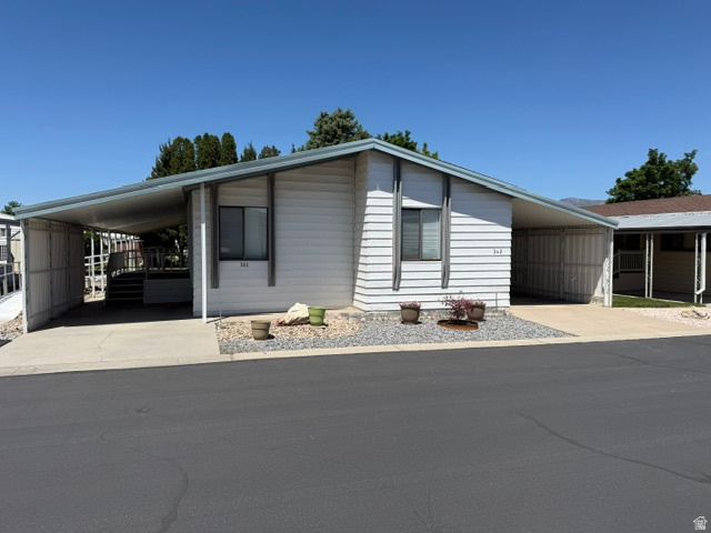Welcome to this beautifully maintained home in a peaceful 55+ community, where comfort, convenience, and stunning mountain views come together perfectly. Offering nearly 1,700 square feet of open living space, this home features a bright and inviting layout designed for easy everyday living and entertaining. The spacious family and living areas showcase upgraded luxury vinyl plank flooring, creating a warm and modern feel throughout the main living spaces, while the bedrooms offer the comfort of brand-new carpet. Large windows allow natural light to fill the home and frame the surrounding mountain scenery.  Designed with accessibility in mind, the home is wheelchair accessible throughout and includes an exterior ramp for easy entry. Whether you are relaxing indoors or enjoying the quiet neighborhood, this home offers both comfort and functionality in an ideal community setting. Don't miss this opportunity to enjoy low-maintenance living in a serene and welcoming neighborhood.