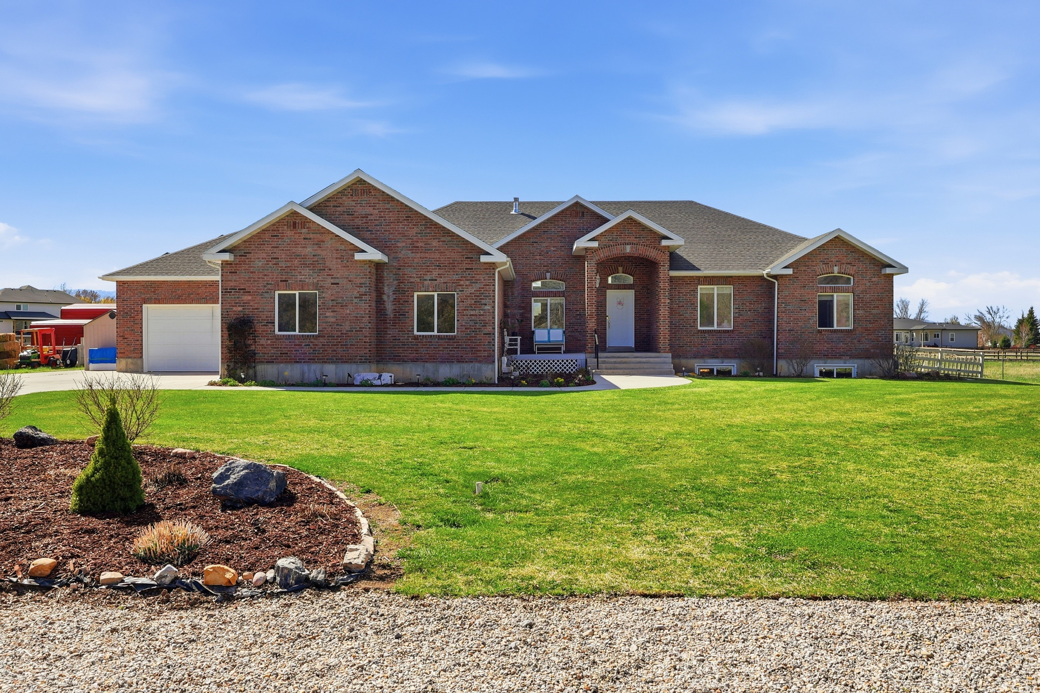 Beautiful sweeping views of both the Bear River and Wellsville Mountains, this all-brick estate offers nearly 4,000 sq ft of beautifully finished living space - plus a lifestyle that's equal parts serene and self-sustaining. Inside, you'll find three spacious bedrooms on the main floor, two more in the finished basement, and a sixth room ready for future expansion. With 3.5 bathrooms, including double vanities in the master with walk in closet, comfort and convenience abound. The kitchen is a warm, inviting centerpiece featuring knotty pine cabinetry, marble countertops, good sized pantry, tile flooring, and a 9-foot ceiling with a service bar that seats three. The vaulted ceilings in the front room give a spacious elegant feeling. The sound system enhances movie viewing without going to the theater. Each bedroom has built in closet organization. With circulating hot water the upstairs has instant hot water at each faucet including the showers. The boiler system enables you to control the temperature downstairs separate from upstairs. Step outside to your own 1.47-acre family farm, complete with a 720 sq ft barn (with loft), a massive 20' x 60' greenhouse with barn-style doors, and a patio deck perfect for summer dining and entertaining under the sunset skies. A 24-panel solar electric system keeps energy costs low while supporting sustainable living. The four-car garage offers ample space for vehicles, toys, and tools - all while enjoying the peace and privacy of country living just minutes from town. https://www.zillow.com/view-imx/a116be08-e65d-4f91-8e27-3a9cf1a69b2c?setAttribution=mls&wl=true&initialViewType=pano&utm_source=dashboard