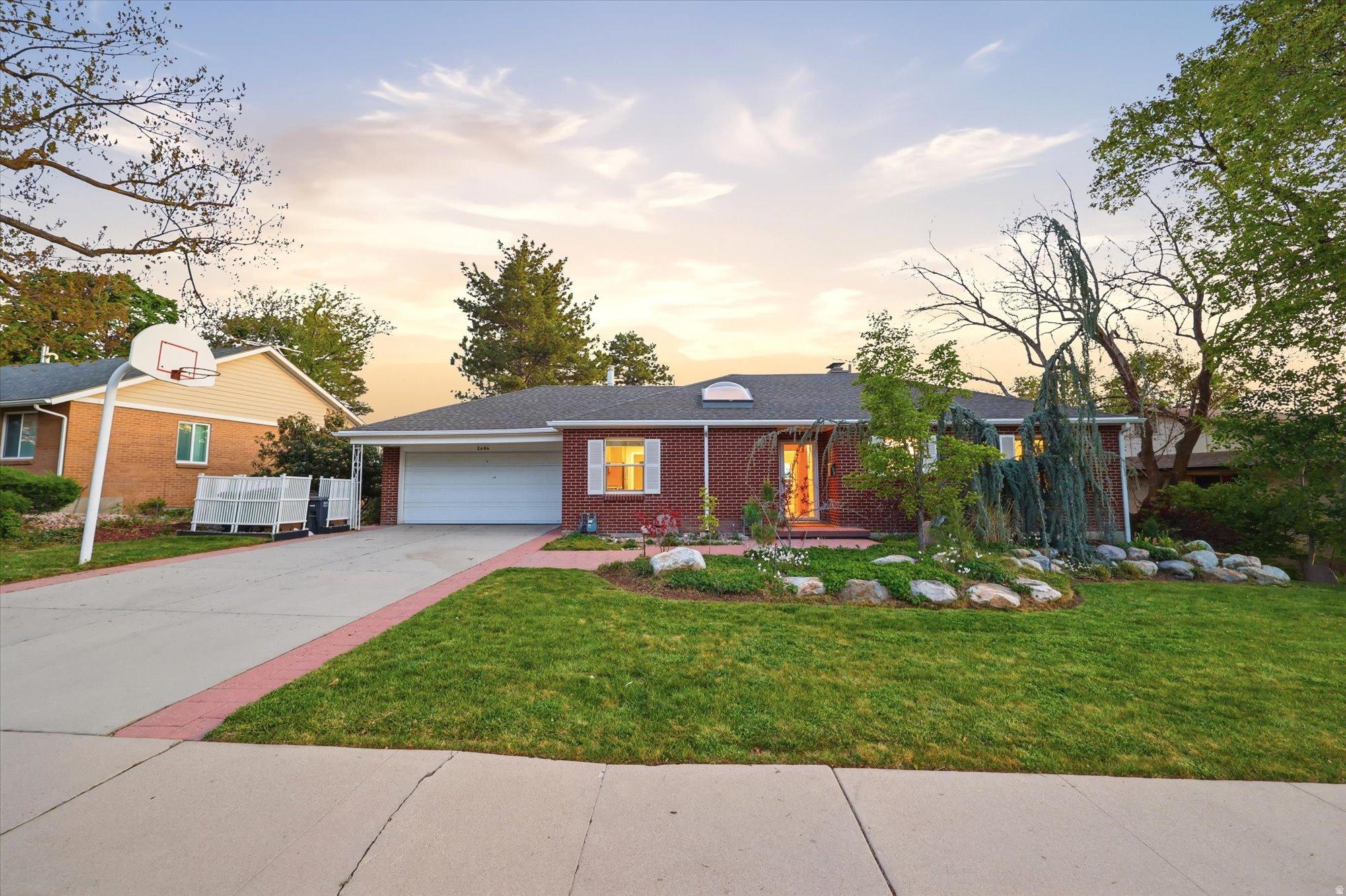 Tucked within one of Salt Lake's coveted interior East Bench residential pockets, this bright and spacious brick home offers a rare combination of privacy, mountain views, and expansive two-level living. The open main floor is filled with natural light and flows seamlessly to a dramatic rear elevation overlooking the beautifully landscaped backyard. A skylit stairwell enhances the sense of openness, while the fully functional lower level-with fireplace, oversized bedroom, separate entrance, and generous additional living space-creates flexibility rarely found in homes of this style. Surrounded by established owner-occupied homes and just minutes from the University of Utah, Foothill Village, downtown, and canyon recreation, this is East Bench living at its best.