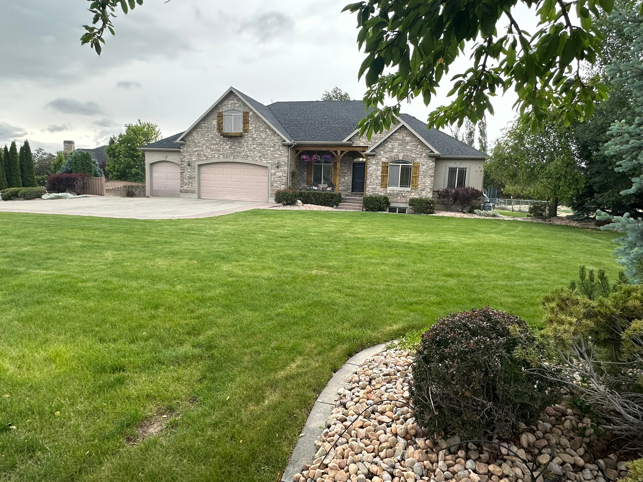 Beautiful Rambler home with mountain views on .71-acre in Highland, conveniently located across from Freedom Elementary.  Entire home recently painted. Main level features open floor plan with formal living room, vaulted family room with fireplace, kitchen and dining area with main level laundry, 5 bedrooms and 3 full bathrooms. Large spacious basement featuring space for office/den/playroom/exercise room and potential ADU for generational living or income potential, 2 bedrooms, 2 full bathrooms, laundry and large storage areas. Beautiful back yard with sidewalks, sport court, large covered patio for entertaining and garden with grow boxes. Save on electricity with the owned active solar panels. Feature includes exterior EV charger and wired 220 outlet for 2nd car charger in the garage. You will love the large 3-car garage with builtin storage cabinets and RV parking. Come enjoy the beautiful sophisticated location with convenient access to trails, schools, shopping, freeway access, Silicon Slopes and just 10 minutes to the Traverse Outlets.