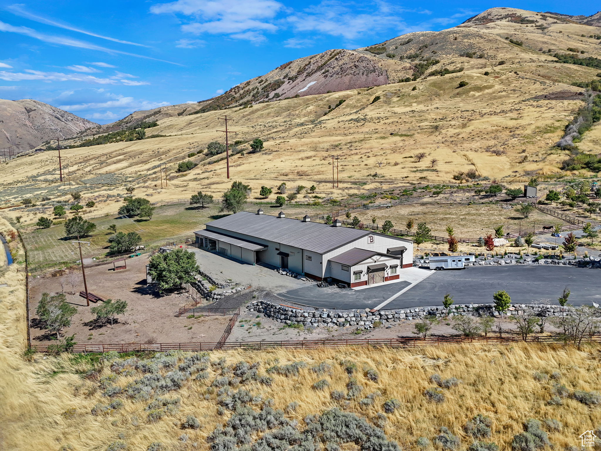 BT Ranch in Brigham City, Utah, is a rare find, offering a harmonious blend of luxury, privacy, and accessibility. Spanning 33 acres and bordering thousands of acres of state and federal land, this ranch boasts breathtaking panoramic views of the valley and Willard Bay, with the majestic mountains serving as a picturesque backdrop. The crown jewels of the property include a 5,073 sqft home, featuring vaulted ceilings, custom kitchens, a spacious master suite, and radiant floor heating, along with a 15,200 sqft horse arena complete with a finished foyer, kitchenette, and viewing platform. Additional amenities include a 4,800 sqft shop with a studio apartment, a gravity-pressurized irrigation system, runouts, stables, and full fencing. This exceptional property is perfect for those seeking a rural retreat with too many modern conveniences to list here.