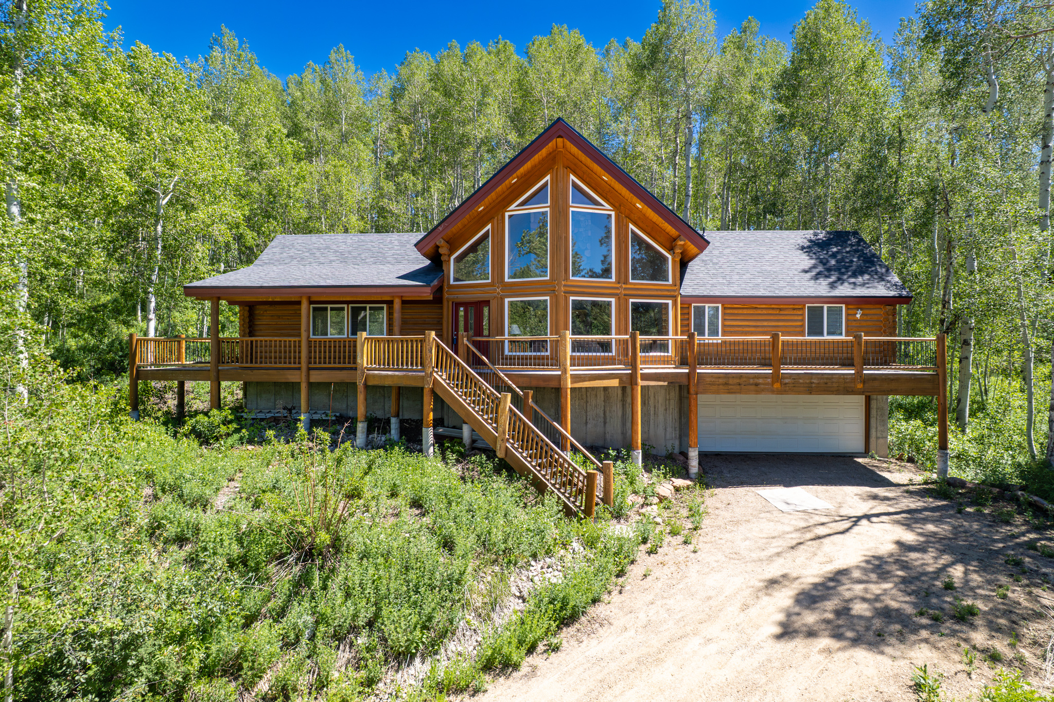 Perched in the upper mountain of Timber Lakes, this stunning log cabin offers a spacious, bright interior paired with breathtaking views and abundant wildlife right outside your door. Soaring vaulted ceilings and expansive windows flood the home with natural light, creating an open and inviting atmosphere, while a beautiful fireplace serves as the focal point. Perfect for cozy mountain evenings!Thoughtfully designed for comfort and functionality with main level primary ensuite with large walk-in closet, this rustic log cabin features generous living spaces ideal for gathering and relaxing. The lower level offers plenty of storage and a built-in sauna, providing the perfect place to unwind after a day of outdoor adventure.New roof in 2024. Sold furnished and ready for immediate enjoyment, this Timber Lakes retreat perfectly blends comfort, scenery and mountain lifestyle. Convenient year round access makes this property enjoyable during every season. Imagine snowmobiling right out your front door into endless private access directly into Uinta National Forest! Only an hour to the SLC airport, 45 minutes to Provo and just minutes from all the fabulous amenities of the Heber Valley, Midway & Park City. Enjoy the beauty of every season with year-round accessibility, whether you're escaping for a peaceful weekend or settling into full-time mountain residence.
