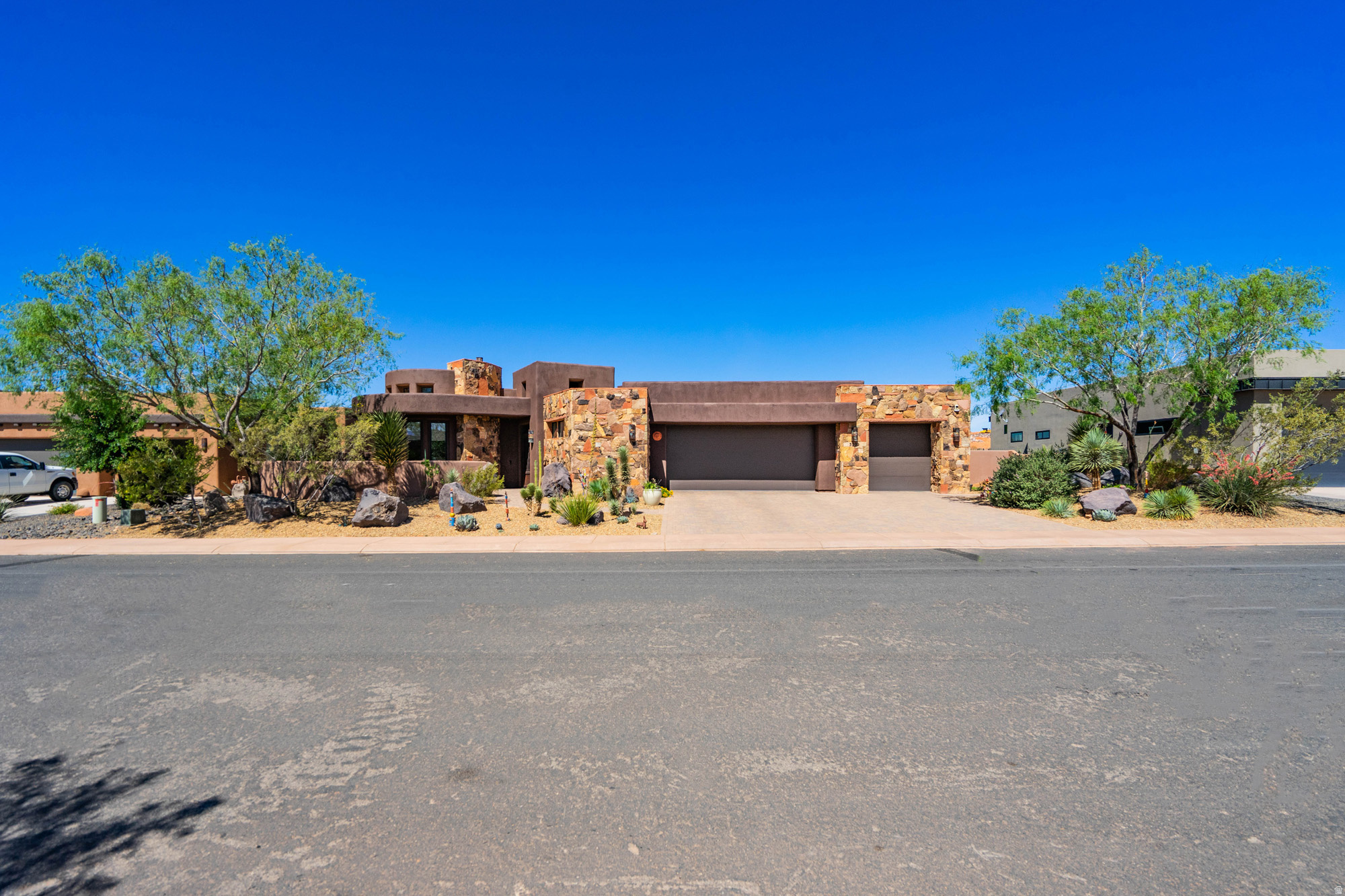 Experience luxury golf course living at its finest in this exceptional custom home perfectly positioned along the 17th fairway of Sand Hollow Golf Course. Designed to capture breathtaking views and seamlessly blend indoor and outdoor living, this residence showcases floor-to-ceiling windows, stunning log beam accents, reclaimed wood flooring, custom granite finishes, and a dramatic gallery hallway that creates an unforgettable first impression. The gourmet kitchen is thoughtfully designed with a large center island, premium finishes, and generous space for entertaining. The versatile floor plan includes a private casita, dedicated office, exercise room, and flexible basement space ideal for additional storage, hobbies, or a future media room. Step outside to your own private resort-style retreat featuring a saltwater pool, hot tub, multiple courtyards, and easy-maintenance landscaping. An expansive upper viewing deck offers panoramic 360-degree views of Zion National Park, Pine Valley Mountain, the surrounding red rock landscape, and the award-winning Sand Hollow Golf Course. The oversized garage includes a workshop area, providing ample space for vehicles, golf carts, toys, and projects. Located within one of Southern Utah's most sought-after golf communities, this extraordinary home offers the perfect combination of luxury, recreation, and unforgettable scenery.