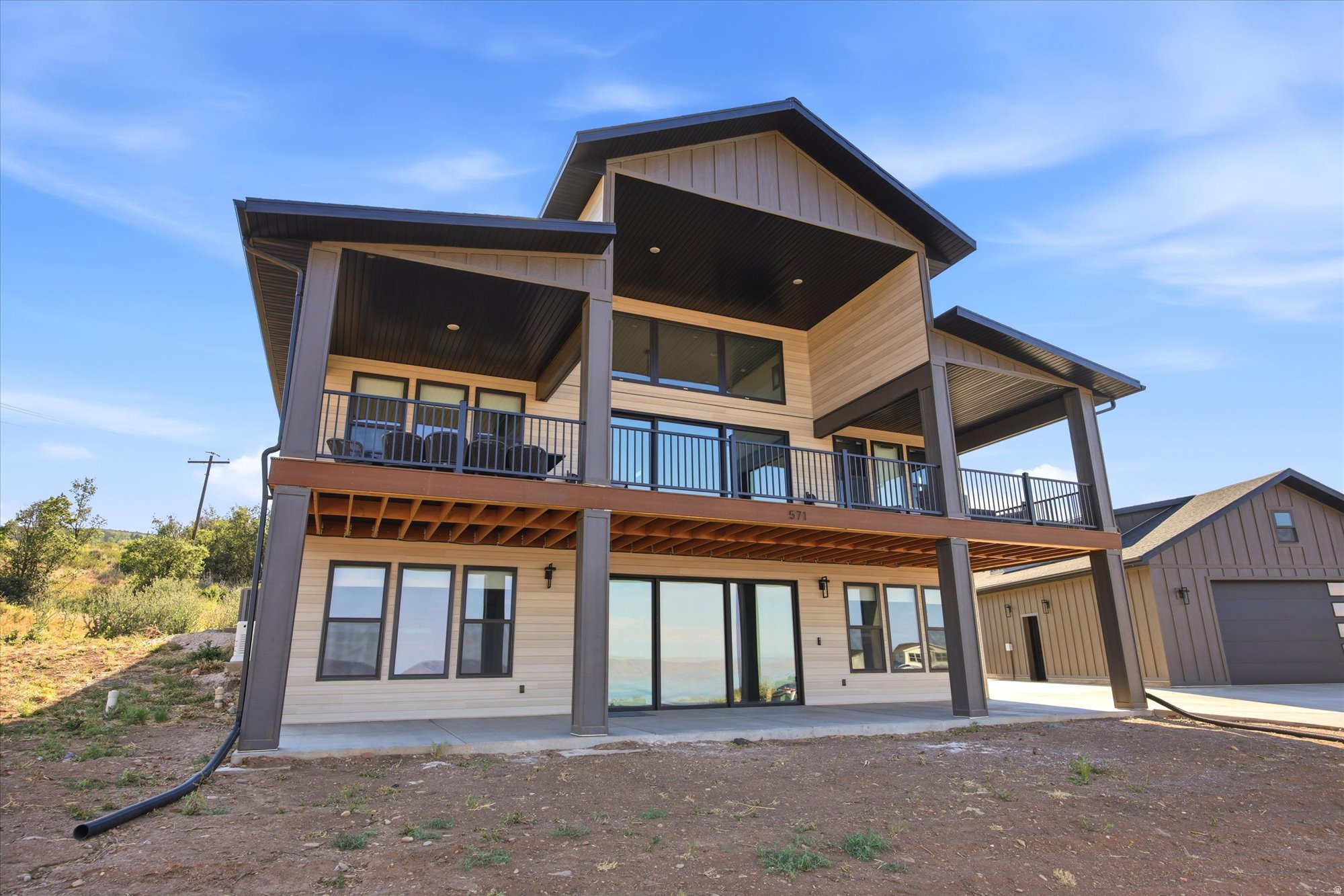 Wow! This incredible new construction checks every box. No detail was overlooked, and every upgrade has already been done. Offered fully furnished, it's completely turnkey and ready to enjoy as a full-time residence, vacation home, or short-term rental. This home has two beautiful kitchens, a butler's pantry, high-end appliances, custom cabinetry throughout, and storage around every corner. Built with ICF block construction, this home was designed with quality, efficiency in mind. The home has a great security system, whole house generator, and a safe room. A large covered deck with plenty of room for outdoor dining, entertaining, or simply enjoying the view of the lake. If you love to entertain, this property delivers. Outside you'll find a pickleball court and basketball hoop. The walkout basement has arcade games ping pong and gaming table. The garage is large and well lit. This is one of those homes you have to experience in person. From the thoughtful design and quality craftsmanship to the incredible amenities and unforgettable lake views, it's built to be enjoyed for years to come.