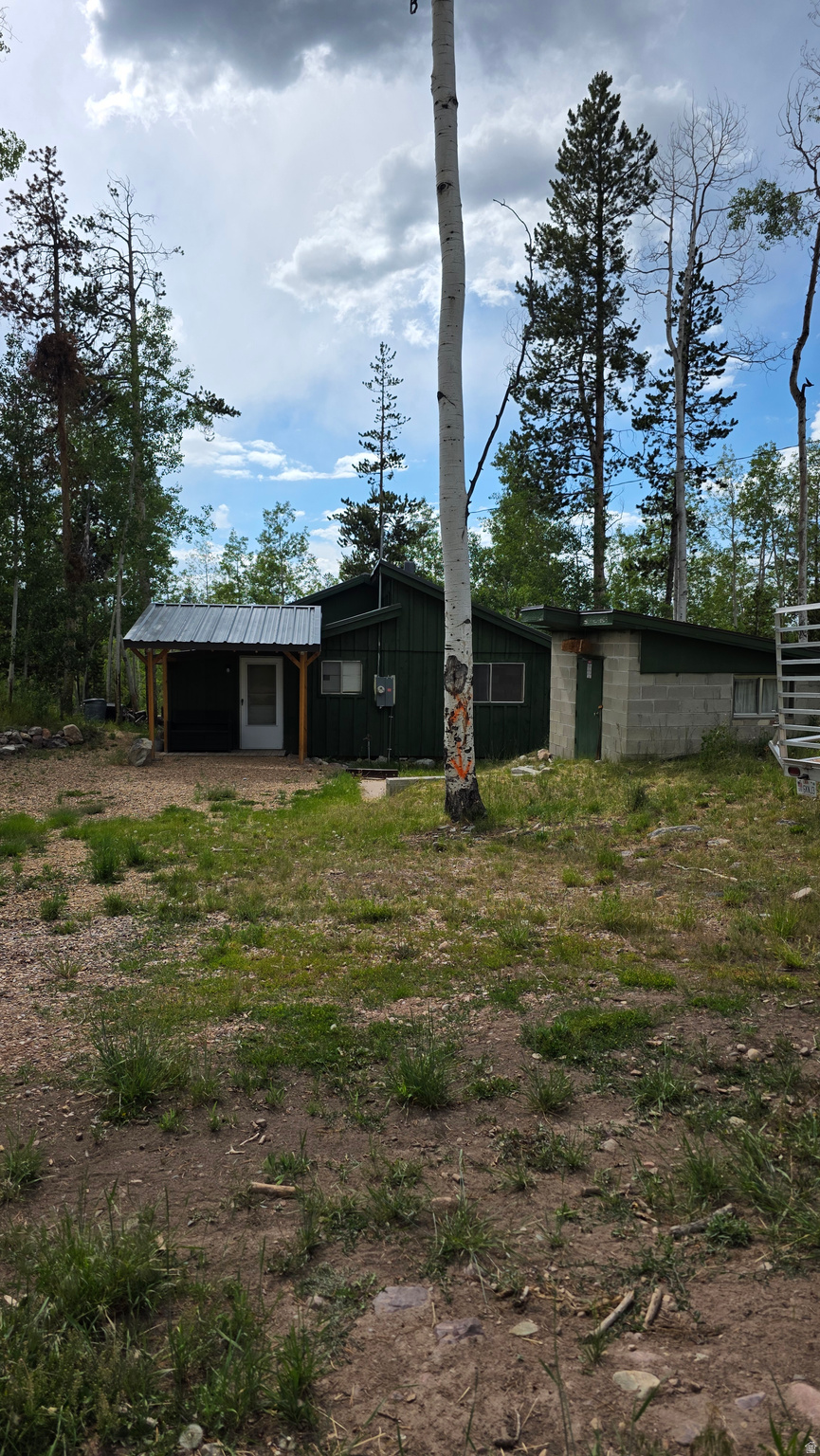 Enjoy the simple charm of having a cozy cabin in the Uinta Mountains. Located in the Manor Lands gated community, this cabin features 2 comfortably sized bedrooms, a full bathroom, a fun little loft for the kids and a welcoming mudroom that adds extra space and storage options. The large deck and additional bunkhouse make it easy to host friends and family, and access to the National Forest is super convenient. You'll be just minutes from endless opportunities for ATV riding, hiking, fishing, wildlife viewing, and exploring the Uintas. The sellers are also selling the adjacent 1.2 acre lot (see land listing MLS#2170506).  Square footage is a courtesy estimate only, buyer is encouraged to obtain and independent measurement.