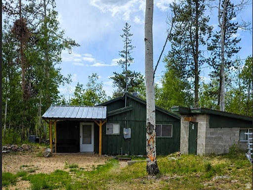 Enjoy the simple charm of having a cozy cabin in the Uinta Mountains. Located in the Manor Lands gated community, this cabin features 2 comfortably sized bedrooms, a full bathroom, a fun little loft for the kids and a welcoming mudroom that adds extra space and storage options. The large deck and additional bunkhouse make it easy to host friends and family, and access to the National Forest is super convenient. You'll be just minutes from endless opportunities for ATV riding, hiking, fishing, wildlife viewing, and exploring the Uintas. The sellers are also selling the adjacent 1.2 acre lot (see land listing MLS#2170506).  Square footage is a courtesy estimate only, buyer is encouraged to obtain and independent measurement.
