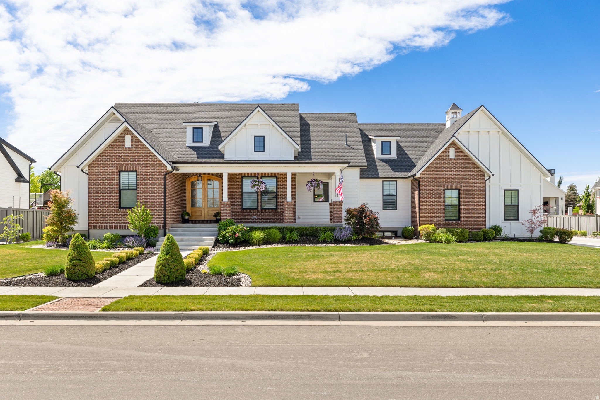 Welcome to one of Kaysville's most stunning properties-a home where thoughtful design, superior craftsmanship, and timeless elegance come together in perfect harmony. Situated in a peaceful neighborhood, this remarkable property offers an unparalleled living experience with every detail carefully curated for comfort, beauty, and functionality. From the moment you arrive, the stunning exterior and grand architectural presence set the tone for what awaits inside. Soaring ceilings, abundant natural light, and exquisite finishes create an inviting atmosphere throughout. At the heart of the home is a truly spectacular gourmet kitchen, featuring a coveted Italian ILVE Nostalgie Series range, custom cabinetry, butler's pantry and rich French Oak hardwood flooring that adds warmth and sophistication. Designed for both everyday living and elegant entertaining, the home offers six spacious bedrooms and six full bathrooms. The luxurious primary suite serves as a private retreat, complete with a spa-inspired bathroom featuring soaking tub, dual vanities, walk-in shower and radiant heated marble flooring for year-round comfort. The expansive family room with gas fireplace, built-in shelves and wood beams open seamlessly to a breathtaking 500-square-foot screened-in porch with wood burning fireplace creates the ultimate indoor-outdoor living experience ideal for relaxing or entertaining in every season.  The lower level is equally impressive, featuring 9-foot ceilings, a spacious family room with gas fireplace and pre-wired for a home theater system, laundry hook ups and a potential kitchen. With direct access from one of the garages, the basement is perfectly suited for an accessory dwelling unit (ADU), offering privacy and independence with all the necessary amenities. Car enthusiasts and hobbyists will appreciate the oversized four-car garage, complemented by generous RV parking. The garage is thoughtfully equipped with a 100-amp electrical subpanel, a full bathroom, and a drinking fountain. Step outside to a beautifully landscaped backyard retreat with an open patio.  A charming 12' x 12' garden cottage enhances the outdoor experience and includes its own 30-amp electrical panel and dedicated circuits for lawn and garden equipment. Efficiency and sustainability were carefully integrated into the home's design. Rain gutters feed into an 1,100-gallon underground water storage system for irrigation and storage purposes, while an extensive French drain system provides exceptional protection against water intrusion. Additional forward-thinking features include provisions for a Generac 25-kW generator, future pool heating, and numerous infrastructure upgrades rarely found in residential construction. Walking distance to top rated Snow Horse Elementary, Centennial Junior High and Jefferson Academy. Offering an extraordinary combination of luxury, innovation, and attention to detail, this one-of-a-kind residence represents the very best of refined Utah living. Schedule your private tour today and discover everything this exceptional Kaysville estate has to offer.
