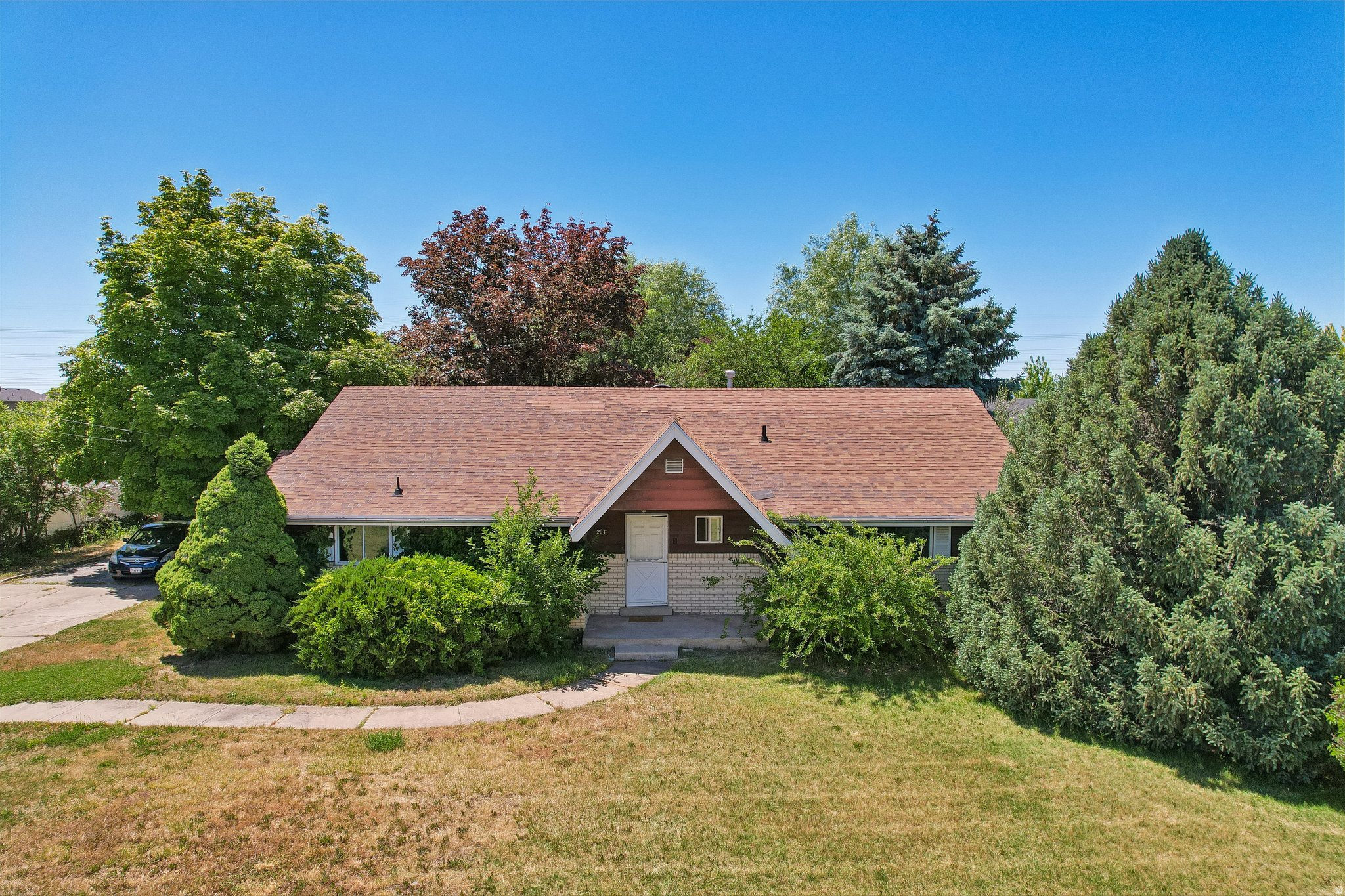 Situated on a sprawling .69-acre corner lot in the heart of Clinton, this property offers space, privacy, and potential that's getting harder and harder to find. Inside you'll find a spacious living area with a cozy fireplace and French doors that open out to your private backyard surrounded by mature trees. The detatched garage, covered storage area, and expansive yard provide plenty of space for hobbies, gardening, toys, or future plans. Full of charm and ready for a new owner's vision, this property offers a rare combination of usable space, established landscaping, and a location close to parks, schools, shopping, and dining.