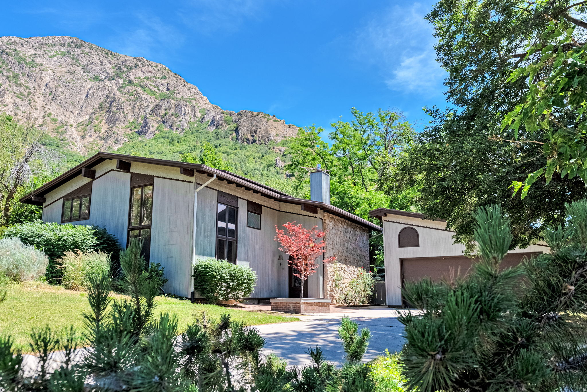 Architectural Legacy on Ogden's Coveted East Bench: Perched gracefully against the mountainside on Ogden's East Bench, this extraordinary residence represents a rare opportunity to own the personal home of renowned architect Richard D. Lowe and interior designer Diane A. Lowe of the esteemed firm Case, Lowe & Hart Architects & Engineers.   Thoughtfully designed as their own private retreat, the home embodies timeless hallmark characteristics of mid-century mountain architecture, seamless integration with nature, and a profound appreciation for light, space, and place.  Nestled among mature landscape and dramatic mountain surroundings, this home offers a living experience unlike any other and reflects the functional elegance and enduring design philosophy that made Richard & Diane Lowe's work so respected throughout the Intermountain West.  Terraced outdoor spaces invite quiet mornings, evening gatherings under the stars, and year-round enjoyment of the remarkable setting. A detached two-car garage complements the architectural aesthetic while providing convenience and additional storage.  Architect-designed personal residences seldom become available, and even fewer possess the historical significance and authenticity found here. More than a home, this is a living work of art-a testament to one of Utah's influential architectural visionary couples and a rare chance to steward a piece of Ogden's architectural heritage.