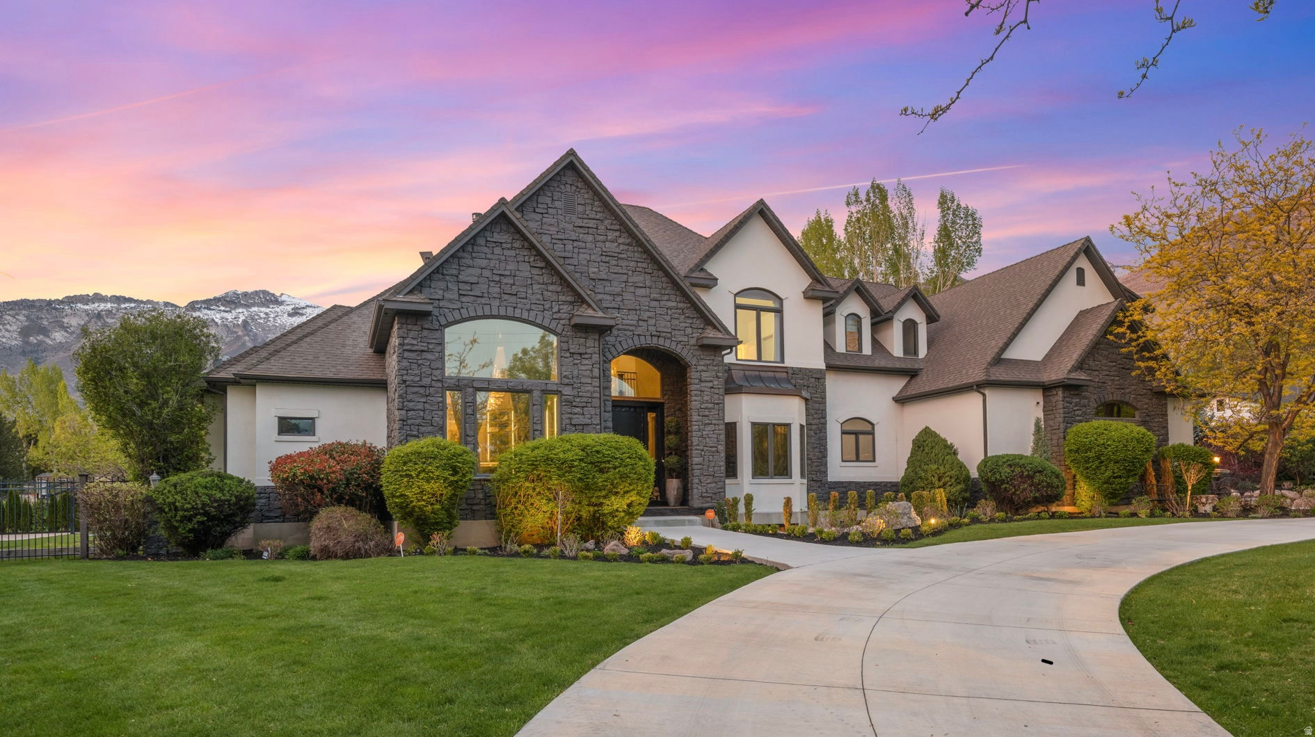 Introducing Lone Peak Estate, a rare offering in the heart of Alpine where refined design meets breathtaking, unobstructed views of Lone Peak and the surrounding Wasatch Range. Set on a private, fully fenced acre, this exceptional residence embodies elevated mountain living with a seamless blend of timeless architecture and modern luxury.                                                                                  From the moment you enter, you're greeted by soaring ceilings, expansive windows, and light-filled spaces that frame the mountain views and bring the outdoors in. The heart of the home is a gourmet chef's kitchen with a butler's pantry, oversized island, and generous gathering spaces which are perfectly suited for both everyday living and entertaining on any scale. With multiple indoor and outdoor living areas, including a covered patio and sport court, this home is truly an entertainer's dream. Designed with flexibility in mind, the home features spacious bedrooms with ensuite bathrooms, a luxurious primary suite with an exceptional walk-in closet, a theater room, and a fully equipped ADU ideal for multigenerational living or extended guests. Additional highlights include laundry on each level, a circular driveway, and both an attached 3-car garage and a detached, extra-deep 2-car garage, offering ample room for vehicles, hobbies, and storage. Perfectly located within Lone Peak High School boundaries, this home offers unmatched access to Utah's outdoor lifestyle just minutes from hiking, biking, and walking trails, and American Fork Canyon. Enjoy being 3045 minutes from world-class ski resorts and just 15 minutes to I-15 and Silicon Slopes, providing both convenience and connection. Lone Peak Estate is more than a home, it's a place to gather, entertain, and experience the very best of Alpine living.Square footage figures are provided as a courtesy estimate only and were obtained from County records.  Buyer is advised to obtain an independent measurement.
