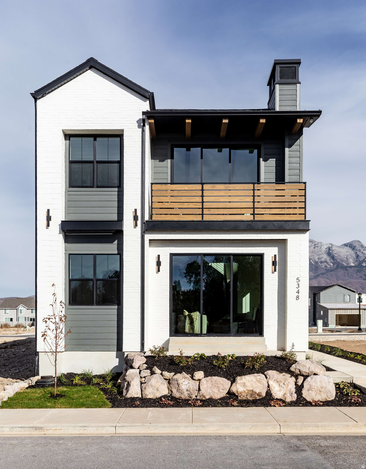Formerly serving as the builder's model home, this meticulously curated 5-bedroom residence represents the pinnacle of Utah County luxury living, positioned just steps from the Alpine Country Club with sweeping views of Lone Peak and Mt. Timpanogos framed from nearly every level. Designer finishes, soaring ceilings, and fully integrated smart home technology set the tone from the moment you enter. The main floor flows effortlessly between a spacious private office, formal living and dining areas, and an oversized chef's kitchen with a dedicated butler's pantry - all opening to the outdoors through a dramatic 12' sliding door that blurs the line between inside and out. Upstairs, the bold Primary Suite commands its position alongside two additional bedrooms, each thoughtfully oriented to capture the mountain panorama. A fireplace on every level - main, upper, and lower - anchors the warm, elevated lifestyle that Highland is known for. The finished basement extends the home's livability with 9' ceilings, a fully appointed wet bar, a private en-suite guest bedroom, and a secondary bedroom ideal for family or long-term guests. Smart home conveniences include a 3-zone Sonos audio system and comprehensive interior and exterior camera coverage. Situated within the prestigious Alpine School District and minutes from American Heritage School, the location is as practical as it is enviable. Select furnishings available for purchase. Buyer to verify all information.  Virtual Tour Link: https://my.matterport.com/show/?m=URVG4jVe5Qc