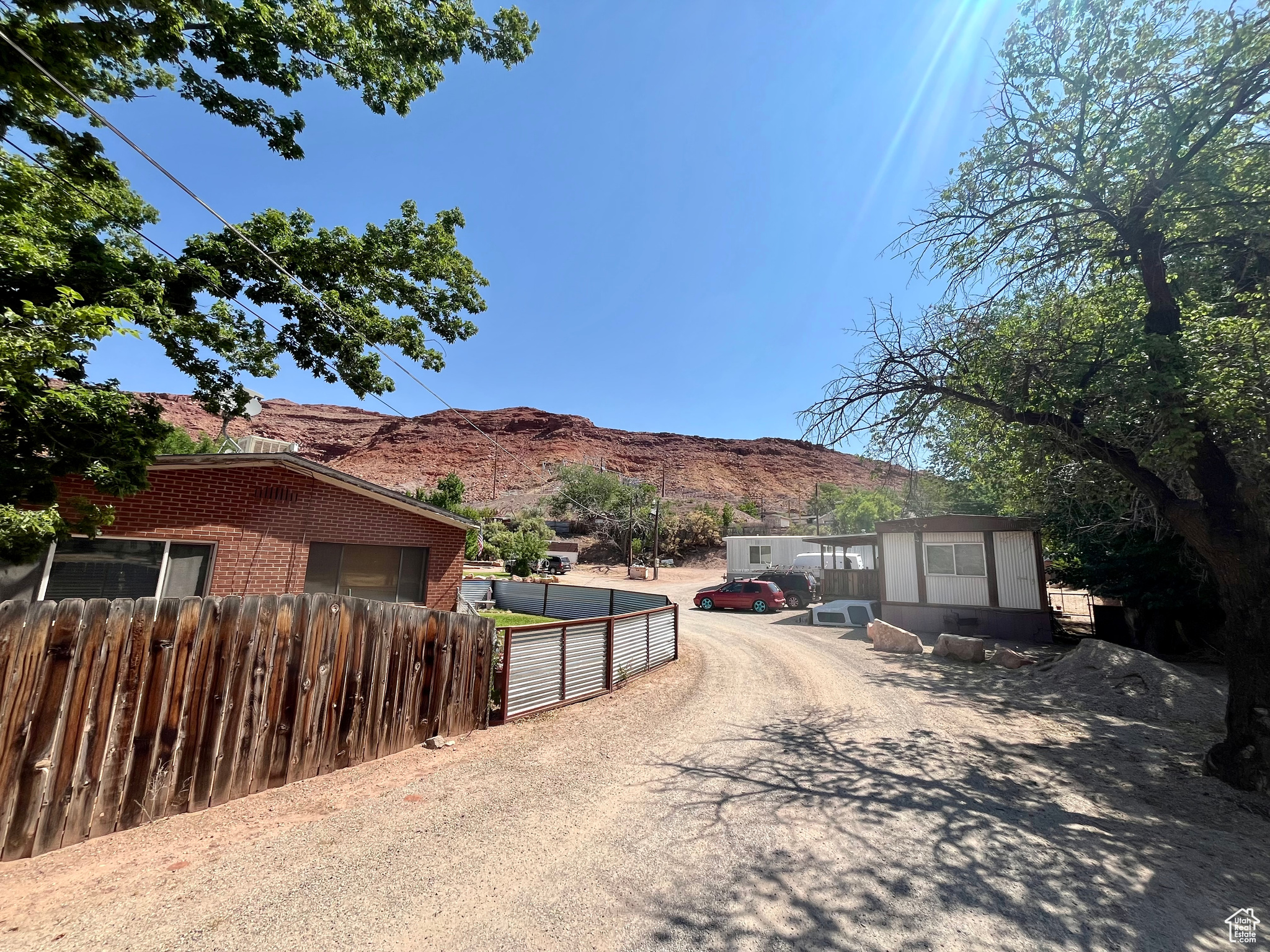 HOME and TRAILER PARK....INVESTMENT OPPORTUNITY located just 2 blocks from MOAB Main Street. This 1 acre parcel is in a prime location for a much needed housing development, or keep the home and trailers for monthly cash flow. Currently this property features a 1231 sq ft home with 3 bedrooms and 1 bath. This brick home was totally remodeled around 1990 and again around 2010. The last remodel included an entirely new bathroom, new plumbing, new flooring and new paint. The home rents for $900 on a month-to-month lease, and it has a good established tenant. This property also includes 6 trailer spaces in which 4 trailers are owned, one space is rented and one space is vacant. The 4 included trailers have 2 bedrooms/1 bath each with approx 750 sq ft. #1 and #2 were remodeled 6-7 years ago. Rent for the owned trailers run from $780 to $900 per month and the space rent goes for $475 per month. Each rental has separate power and gas meters and Seller pays for W/S/G. These rent amounts are kept low because tenants have been in the park for many years. Refrigerator and range in the home belong to renter. Range in #6 belongs to the renter. All square footage numbers are approximate. Buyer to verify all information to their own satisfaction.
