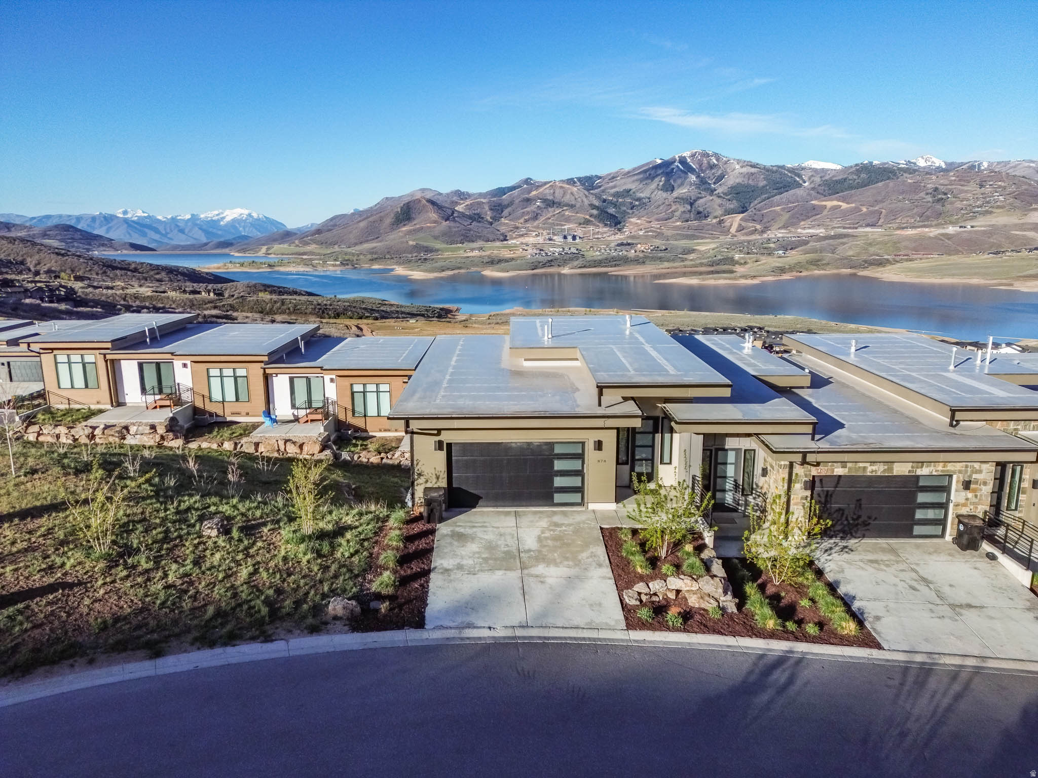 Experience refined mountain living in this exceptional downhill end-unit, perfectly positioned to capture sweeping views of the lake and the iconic Mount Timpanogos. Bordering open space, this residence offers a rare sense of privacy and tranquility, making it an ideal retreat or premier investment opportunity. Offered fully furnished and turnkey, the home seamlessly blends comfort and sophistication. The expansive floor plan features three generously sized bedrooms and three well-appointed bathrooms, complemented by a large chef's kitchen and an open-concept living area designed for effortless entertaining. The primary suite is a private sanctuary, complete with a spacious spa-inspired bathroom and an oversized walk-in closet. The lower level hosts two additional bedrooms, each thoughtfully designed, with direct walk-out access to a secluded outdoor space featuring a hot tub-perfect for unwinding beneath the mountain sky. This is a rare opportunity to own a distinguished property where elevated design meets unparalleled natural beauty. All information is deemed reliable but is not guaranteed and should be independently verified.