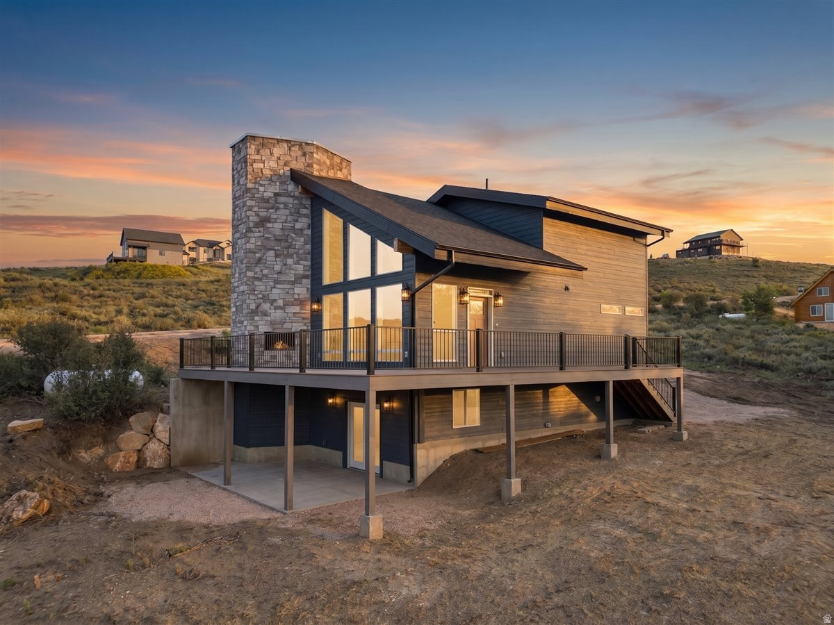 This beautiful and brand-new mountain retreat offers the perfect, private getaway near Bear Lake. This home offers something rare: a true "mountain life" experience, where you're likely to get frequent visitors in the form of deer, moose, and wild turkeys. Take in breathtaking views of the lake and surrounding mountains from the expansive deck, which features a stunning outdoor gas fireplace-with the push of a button, you'll be perfectly cozy as you stargaze. A second gas fireplace inside brings the same warmth indoors, where you'll find high-end and thoughtful finishes throughout a convenient and well-planned home. The basement, with roomy nine-foot ceilings, is already framed, insulated, plumbed, and prepped for additional living space, including a designated area for a future fireplace. In other words, this is a property with plenty of space to grow or host your loved ones. Additional amenities here include full RV hookups with power, water, and sewer (which creates yet another opportunity to host, while keeping the main property to yourself). The attached single-car garage provides year-round access and is equipped with EV charging capability, and the oversized lot offers plenty of options for future landscaping, lawn space, or even a sports court/playground. In June, an asphalt driveway will be installed at no additional cost, lending even more convenience to this lovely home. For those seeking a lakeside retreat with all the perks of the good life, this is your opportunity.   Agent related to seller. Square footage figures are provided as a courtesy estimate only.  Buyer is advised to obtain an independent measurement.