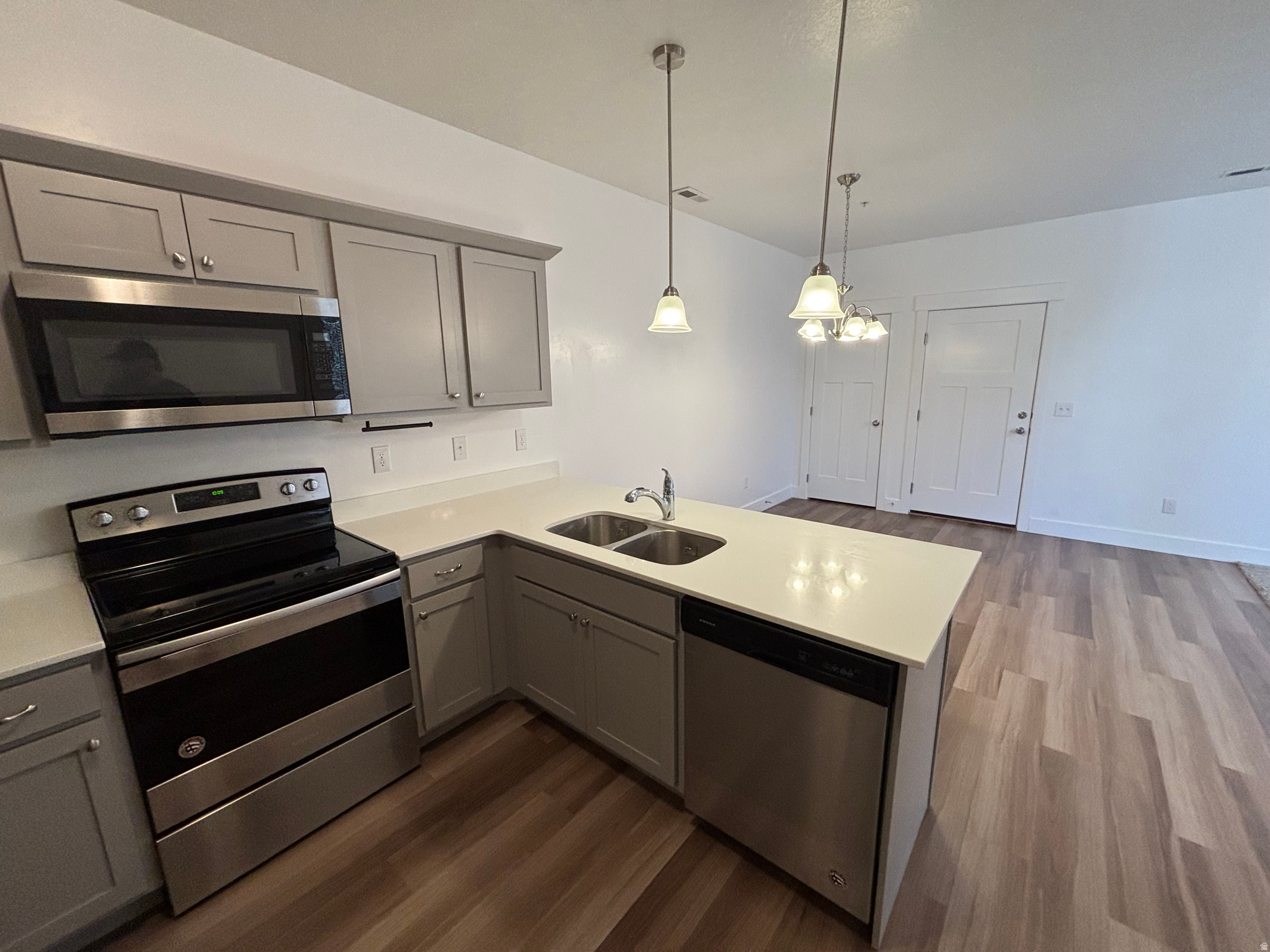 Welcome home! This beautifully maintained condo offers the perfect combination of style, convenience, investment potential, and low-maintenance living in one of Lehi's most desirable communities. One of the standout features of this home is that it is located in a section of the community where long-term rentals are permitted, making it an excellent opportunity for both homeowners and investors. Inside, you'll find an open-concept layout featuring durable luxury vinyl flooring, quartz countertops, stainless steel appliances, abundant natural light, and modern finishes throughout. The spacious primary suite offers a double vanity, walk-in closet, and private bath, while the additional bedrooms provide flexibility for family, guests, or a home office. You'll also appreciate the oversized attached garage with extra storage and the convenience of an in-unit laundry room. Located in The Exchange community, you'll enjoy incredible amenities including a clubhouse, pool, fitness center, pickleball and basketball courts, playgrounds, and walking paths. Just minutes from Silicon Slopes, Thanksgiving Point, shopping, dining, Mountain View Corridor, and I-15, this location offers an easy commute throughout Utah County and Salt Lake County. Whether you're looking for your next home or a smart investment property, this move-in-ready condo checks all the boxes!