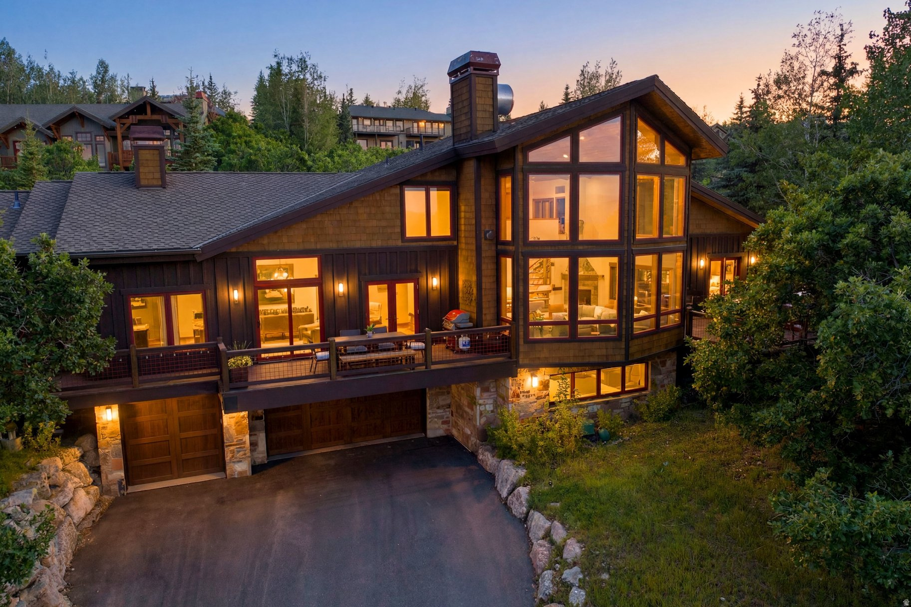 Every great mountain home tells a story, and at 1554 Aerie Drive, that story begins with mornings overlooking the Wasatch Range, afternoons spent exploring nearby trails, and evenings just minutes from the energy of Historic Main Street. Perfectly positioned on a coveted corner homesite in Park City's Aerie neighborhood, this residence offers the rare balance of privacy, convenience, and timeless mountain elegance.  Designed for effortless living and memorable gatherings, the home's open floor plan unfolds around an inviting great room where soaring ceilings and expansive windows frame the surrounding mountain views. At its heart, the chef's kitchen is beautifully equipped with custom cabinetry, a Sub-Zero refrigerator, and a Wolf dual-oven range-equally suited for quiet family breakfasts or aprs-ski dinners with friends.  The main level lives with remarkable ease. A private office provides an inspiring place to work or create, while an ensuite guest bedroom offers comfort and privacy for family and visitors. Tucked away in its own secluded wing, the primary suite serves as a peaceful retreat, complete with dual walk-in closets, a spa-inspired bath, private laundry, and direct access to a tranquil patio where mornings begin with fresh alpine air and evenings end beneath brilliant mountain skies.  Upstairs, a spacious family room opens to a south-facing deck, creating a welcoming destination for guests or the next generation to gather. Two additional ensuite bedrooms ensure everyone enjoys their own private sanctuary while remaining connected to the home's inviting social spaces.  Every detail has been thoughtfully considered for life in the mountains. A custom mudroom with built-in ski lockers keeps every adventure organized, while the dedicated wellness area and oversized three-car garage provide generous space for vehicles, bikes, skis, golf clubs, and all the gear that makes Park City living so exceptional.  Just moments from Deer Valley, Park City Mountain, Historic Main Street, and a neighborhood trailhead steps from your door, 1554 Aerie Drive places year-round adventure within easy reach. Whether your day begins on the slopes, hiking scenic trails, or enjoying dinner downtown, this is a home designed to make every season feel extraordinary-a place where family traditions are created, lifelong memories unfold, and the very best of Park City becomes part of everyday life.