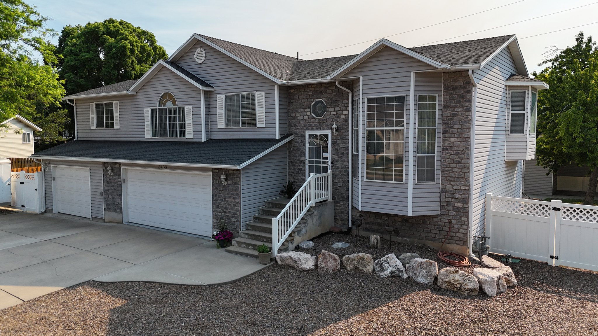 You'll want to see this in person! Both interior and exterior spaces have so much to offer. 4 Bedrooms 3 Bathrooms is a great living space, not to mention the huge 3 car garage/shop that is heated with EV charging wiring ready. The third car garage fits a four-door long bed dually truck) The top floor has an open kitchen and dining area, leading out to a wonderful covered deck, overlooking the salt water pool. This floor also has the master bedroom and bathroom, two additional bedrooms and another full bathroom, along with the laundry room. The middle floor offers an open family room as you enter the front door. The bottom floor has another open living room with a wood fire place, and a large bedroom that walks out to the pool area. The back yard is a water wonderland with a 20x40 heated pool with delightful water features. As you walk around the outside of the house you'll find a mature Bing cherry tree, tons of storage in the well built outbuildings with full power roll up doors and full power lights and outlets, RV parking driveways on on both sides of the house with access gates, and tons of parking in the in the front driveway. The house is located near Riverdale Rd and Ogden downtown shopping. And the peaceful nature area of the Hunter Spring Trailhead by the Weber River is a block away from the front door. Enjoy your new home!