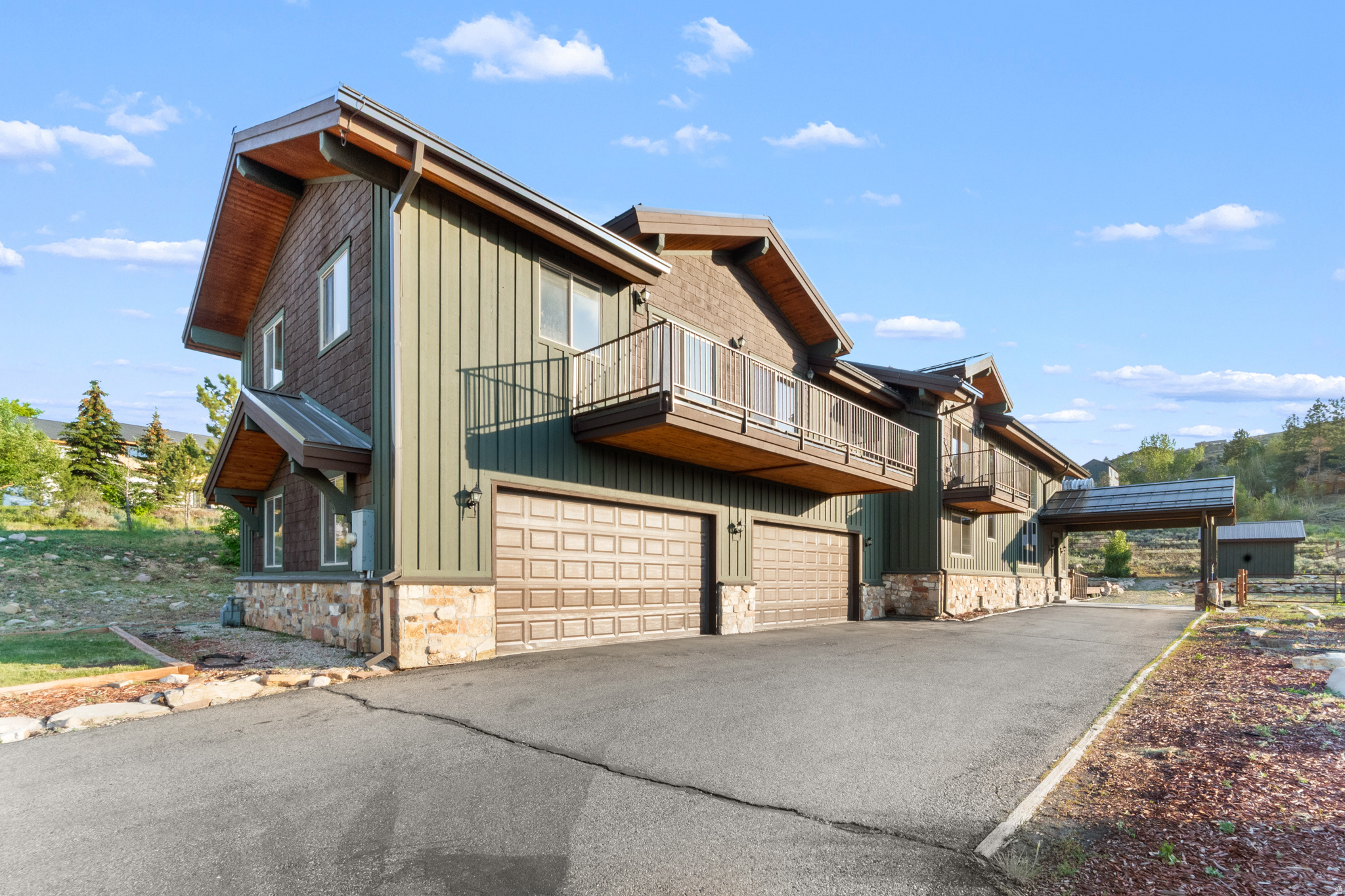 Experience mountain living at its finest in this stunning custom Park City home. Situated on nearly three quarters of an acre and offering over 4,500 square feet of thoughtfully designed living space, this home blends timeless craftsmanship with warmth and comfort. The open-concept floor plan is highlighted by soaring 25-foot vaulted ceilings, rich Brazilian mahogany hardwood floors, and a striking 6-foot-wide staircase that serves as the home's architectural centerpiece. Upstairs, a spacious loft provides the perfect flex space for entertaining, a media room, home office, or additional gathering area. The chef's kitchen is designed for both everyday living and hosting, featuring a 6-burner gas cooktop, custom granite countertops with detailed edgework, and seamless flow into the inviting great room, where a cozy gas fireplace creates the perfect setting for relaxing evenings with family and friends. The luxurious primary suite offers a private fireplace, spa-inspired ensuite with a jetted soaking tub, and a steam room-creating your own private mountain sanctuary. Step outside to the expansive patio, ideal for al fresco dining, summer evenings under the stars, or simply taking in the peaceful surroundings. Conveniently located just minutes from world-class skiing, hiking, shopping, dining, and all that Park City has to offer, this exceptional property is perfectly suited as a full-time residence, luxury mountain getaway, or investment opportunity.