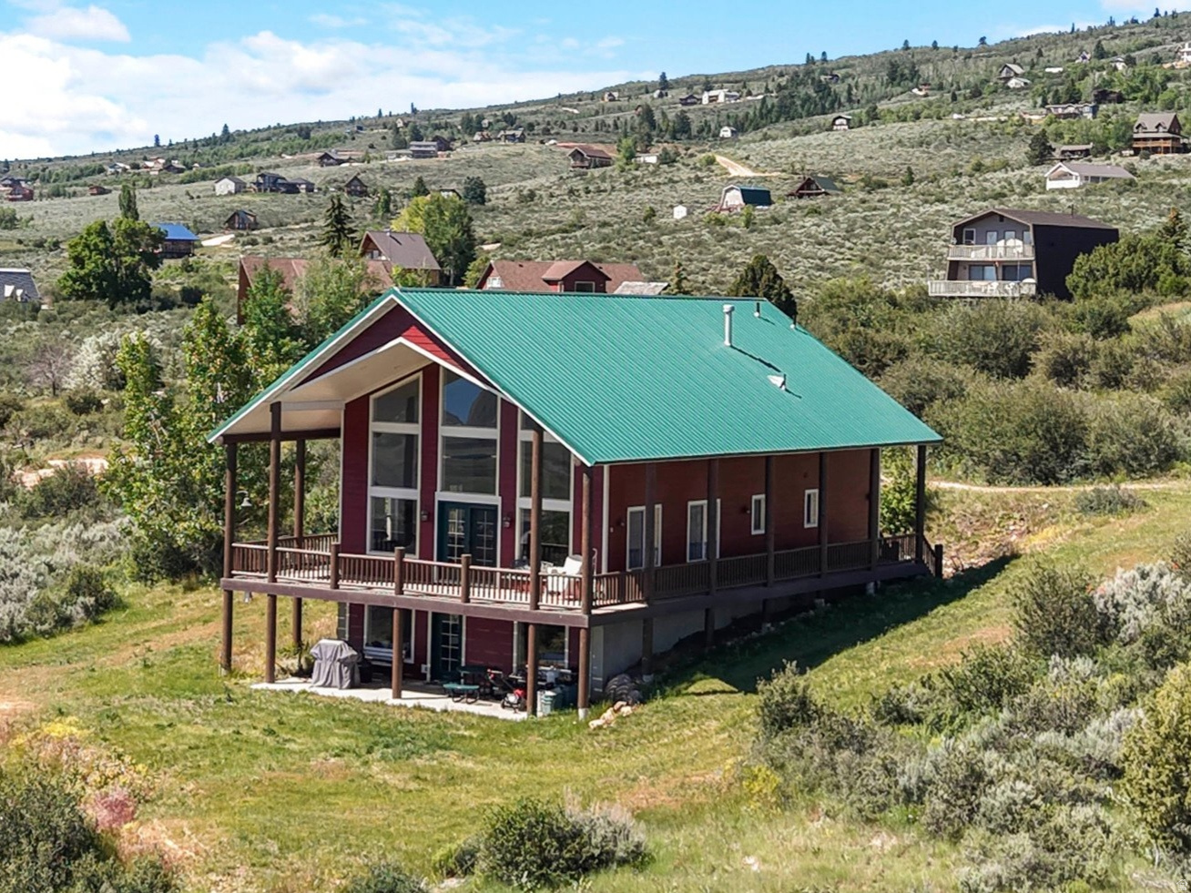 Beautiful Bear Lake retreat on just over one acre with breathtaking lake views! Perfect for year round enjoyment, this home offers stunning panoramic views through large picture windows and from the spacious covered wrap around deck.  Cozy up by the fireplace on chilly winter days or unwind outdoors while taking in the fresh mountain air and spectacular scenery throughout the spring, summer, and fall.  Whether you're looking for a vacation getaway, or full time residence, this Bear Lake home is the perfect place to create lasting memories.  Amenities available for an additional fee include: Beach access, swimming pools, tennis/pickleball, and mini golf.   Square footage figures are provided as a courtesy estimate only.  Buyer is advised to obtain an independent measurement.