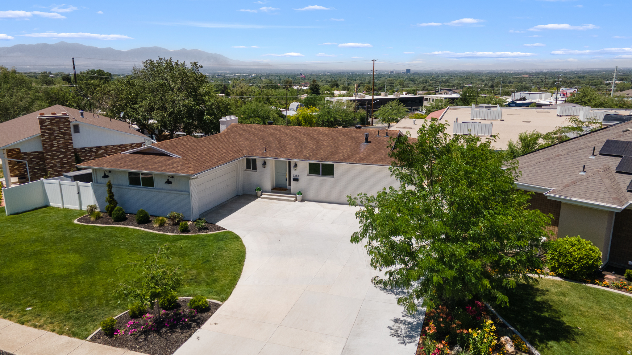 Welcome to 2353 Cinnabar Lane, a thoughtfully renovated home in the heart of Cottonwood Heights, offering stunning mountain views from both the front and backyard. Perfectly positioned overlooking the future "The Heights" development (currently Hillside Plaza), this home combines modern updates, flexible living options, and an exceptional location. The main level features 3 bedrooms and 2 bathrooms, including a spacious primary suite with a convenient secondary laundry station. Every inch of the home has been carefully updated with attention to both style and functionality. The lower level offers exceptional versatility with 2 bedrooms, 1 bathroom, and an additional flex space that can be used as an office, gym, playroom, media room, or guest space. Designed as a fully independent walkout basement suite, it includes a private entrance, full kitchen, and dedicated laundry. Previously rented for $2,000 per month, the suite provides excellent income potential as a mortgage helper. For homeowners who do not need rental income, the lower level functions seamlessly as additional living space for family members, guests, or multigenerational living. The garage boasts a new epoxy floor and is equipped with a 220-volt electric vehicle charger. Outside, the extended driveway and well-maintained landscaping provide additional parking and enhance the home's curb appeal. With breathtaking mountain views, extensive renovations, flexible living arrangements, and proximity to one of Cottonwood Heights' most exciting upcoming developments, this home offers a rare combination of comfort, convenience, and long-term value. Square footage figures are provided as a courtesy estimate only and were obtained from county record. Buyer is advised to obtain an independent measurement.