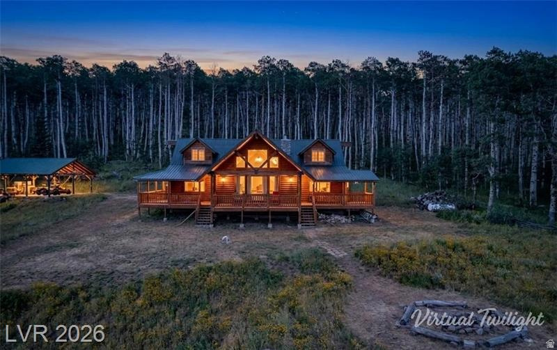 Commanding an elevated position on 20 acres of quakies & open meadow, this cabin captures the majesty of expansive mountain views, open skies, & unspoiled wilderness in every direction. A hunter's haven & mountain sanctuary, it's surrounded by prime deer, elk, & turkey habitat. A pavilion provides a great space for gatherings, parties, & outdoor entertaining. Inside, beautiful rustic log furnishings throughout, vaulted ceilings, & a hand-laid rock fireplace create warm western charm. The main floor offers a great room, dining area, kitchen w/pantry. A primary bedroom w/ en suite, half bath & a mother-in-law's room. Upstairs in the loft features a family room, full bathroom & 3 queen beds. Dish TV keeps you connected, & non-potable deeded spring water is pumped to a tank & gravity fed. Seasonal access. Seller financing available. Adjacent 20 acres available. Selling turn-key.